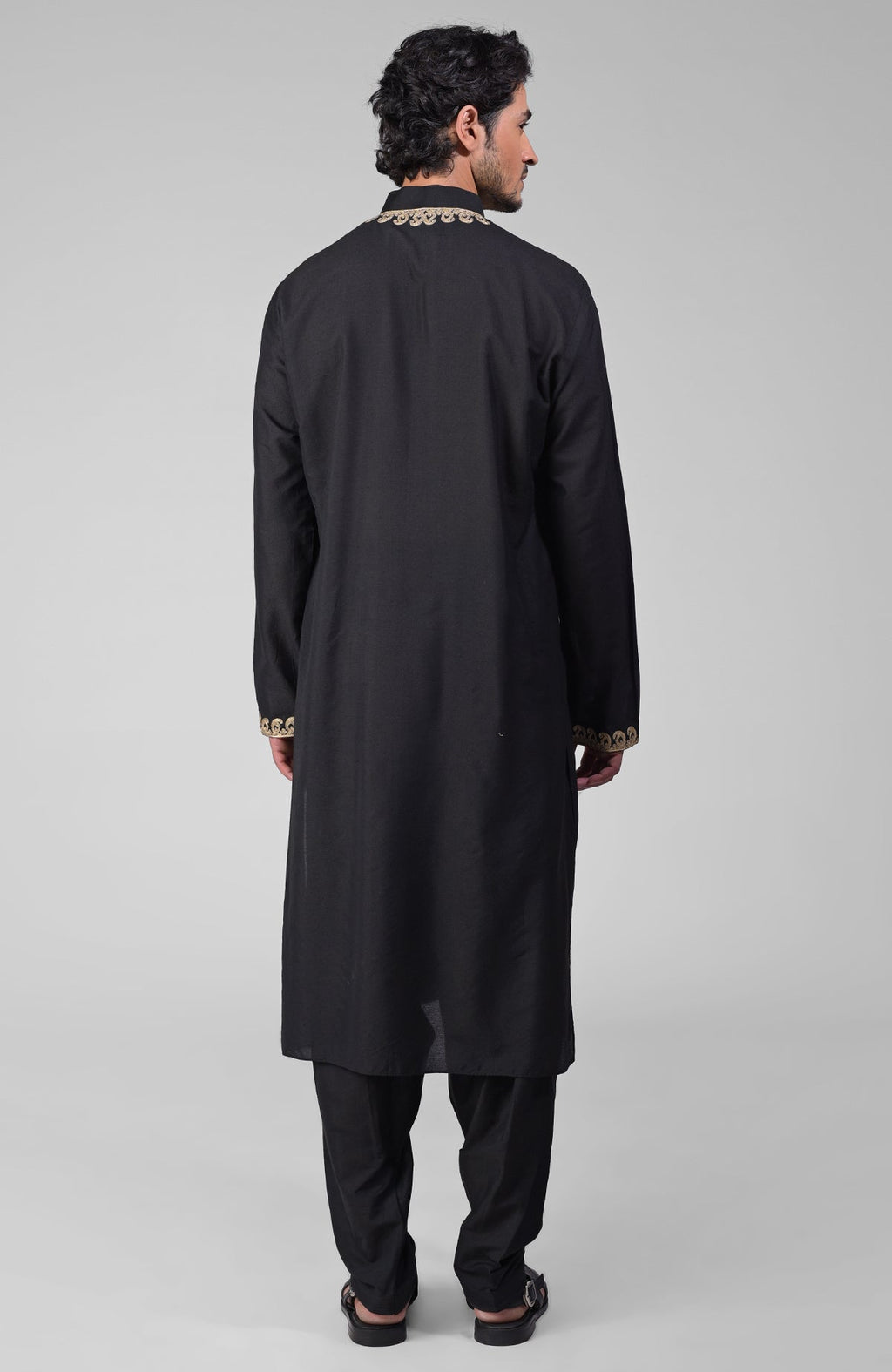 Black silk kurta with gold Kashmiri tilla embroidery paired with matching pathani salwar.