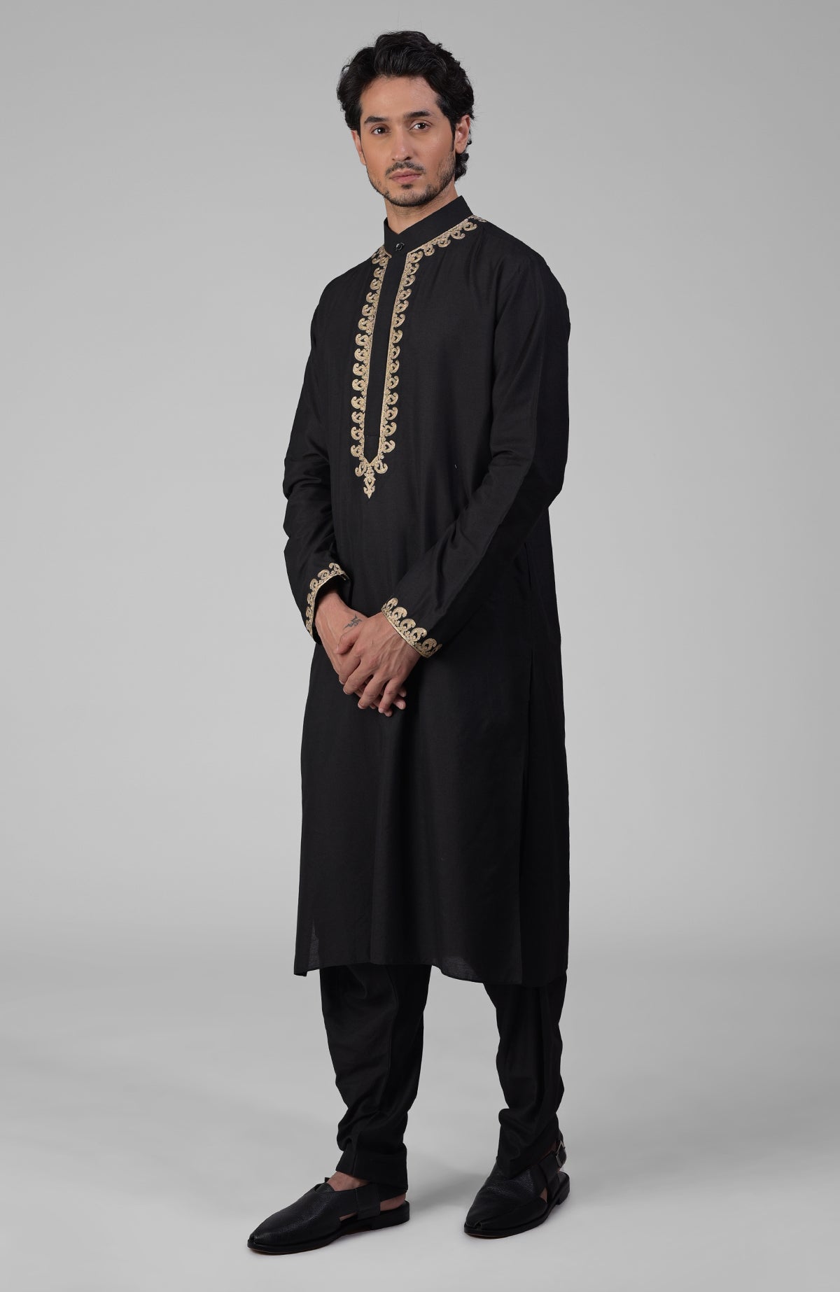 Black silk kurta with gold Kashmiri tilla embroidery paired with relaxed black pathani salwar.