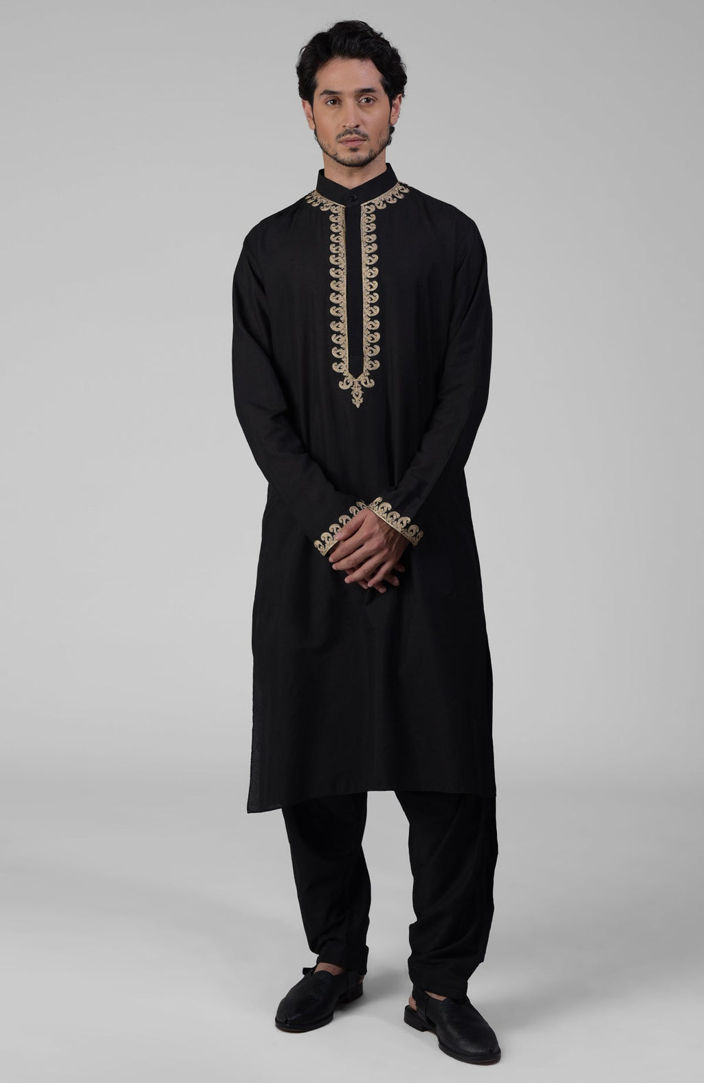 Black silk kurta with gold Kashmiri tilla embroidery paired with matching pathani salwar.