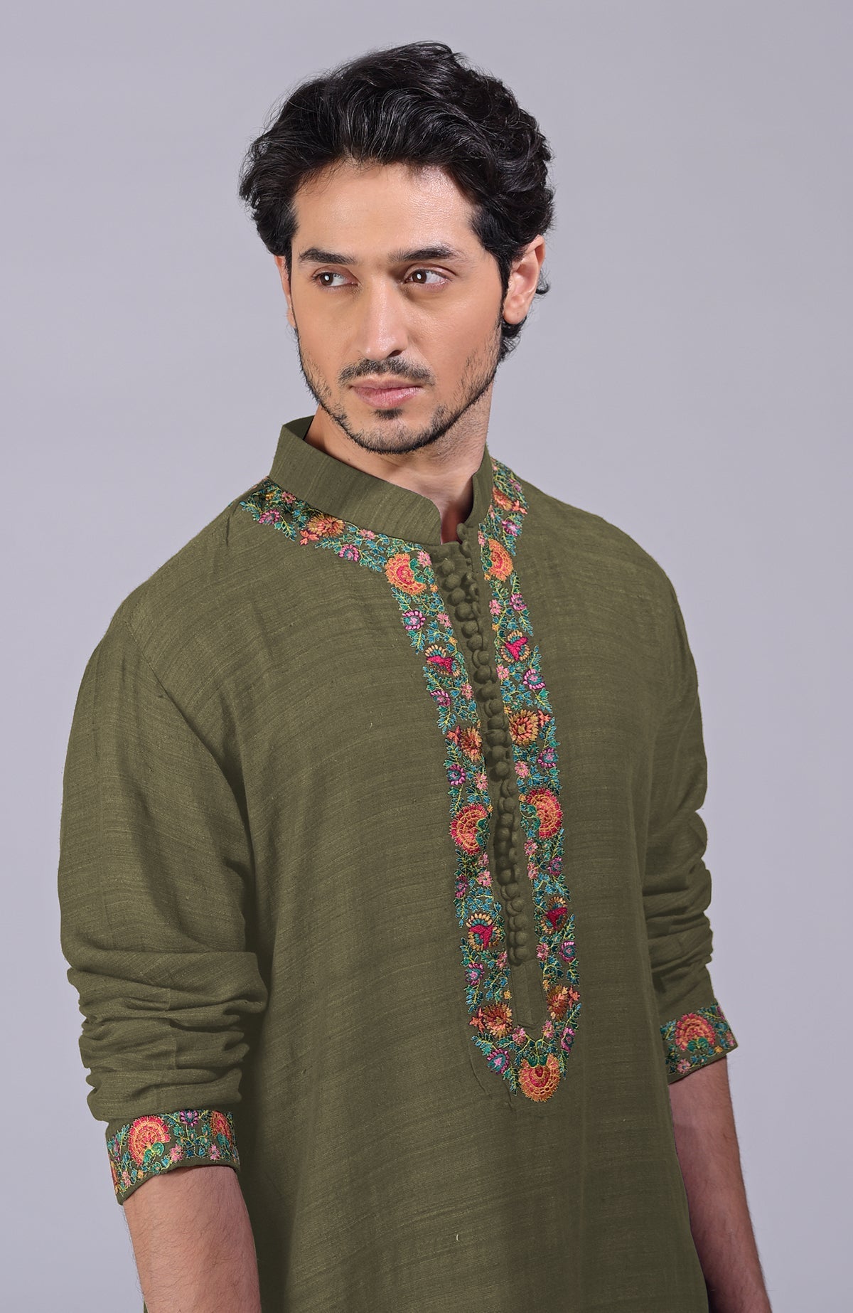 Olive kurta with detailed Kashidakari embroidery on placket, neckline, and sleeves.