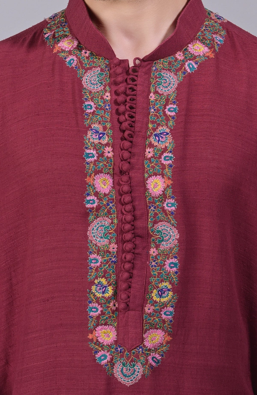 Maroon kurta with intricate Kashidakari embroidery on placket, neckline, and sleeves.