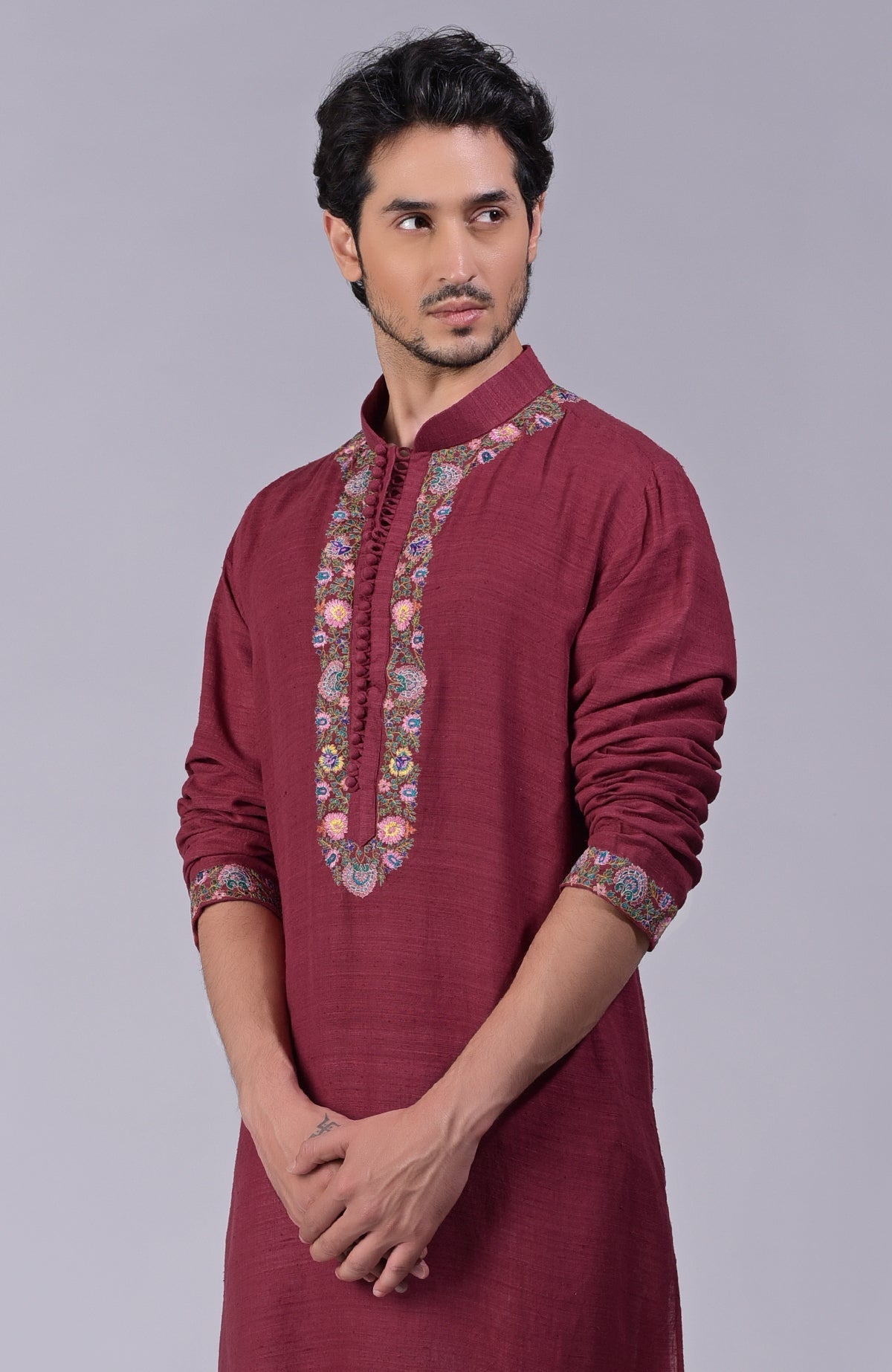 Maroon kurta with intricate Kashidakari embroidery on placket, neckline, and sleeves.