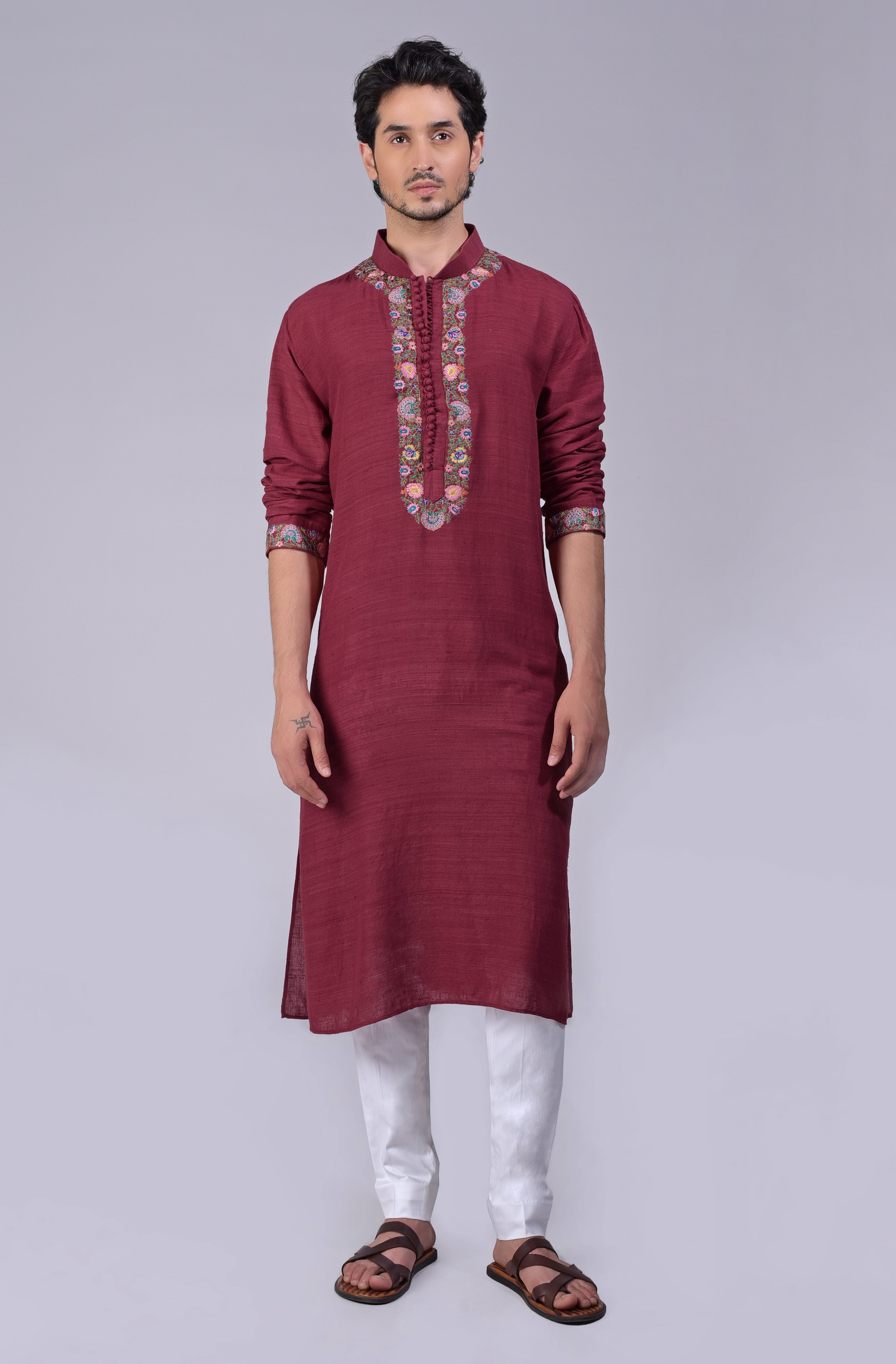Maroon kurta with intricate Kashidakari embroidery on placket, neckline, and sleeves.