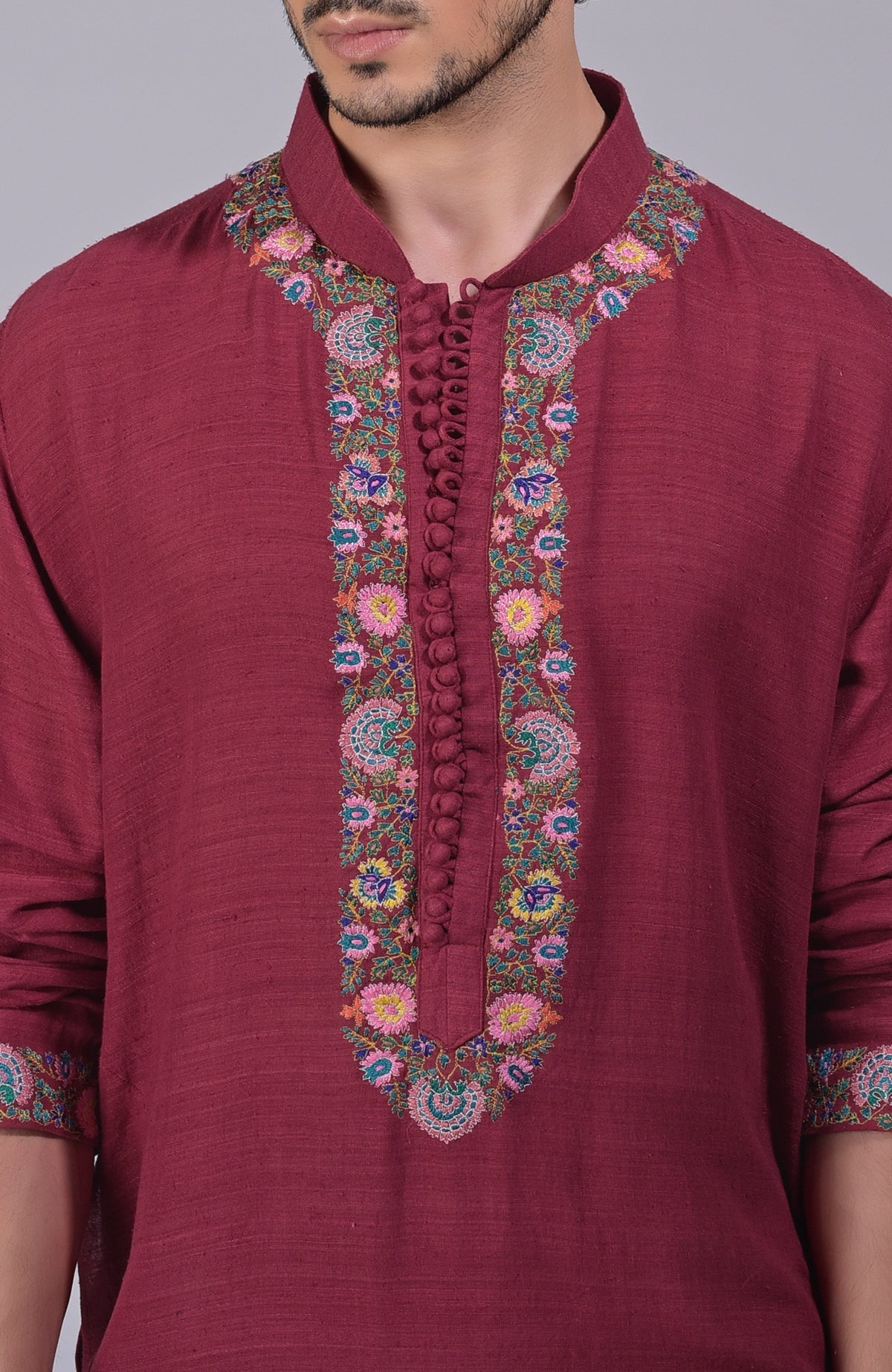 Maroon kurta with intricate Kashidakari embroidery on placket, neckline, and sleeves.