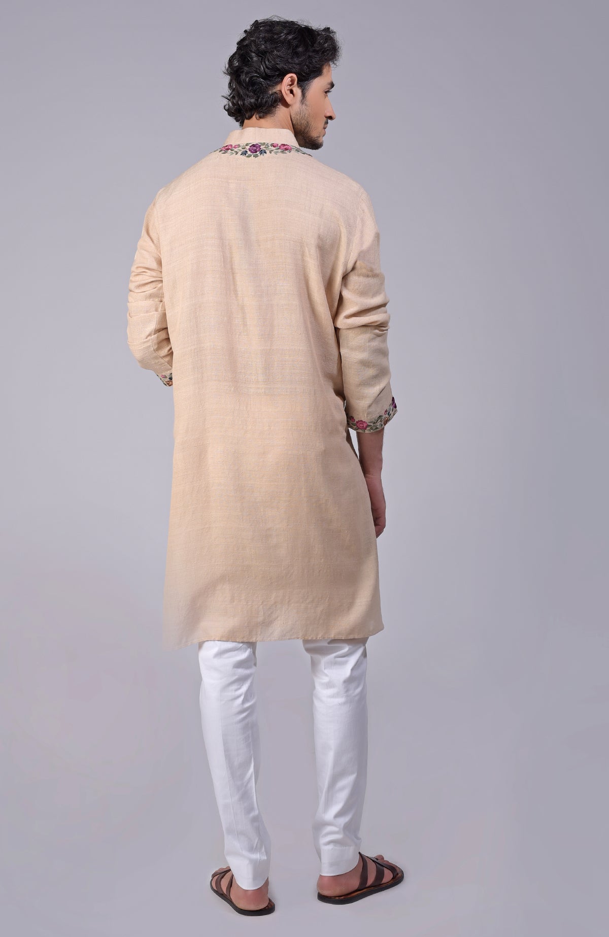 Beige kurta with multicolor Parsi Gara embroidery on placket, neckline, and sleeves.