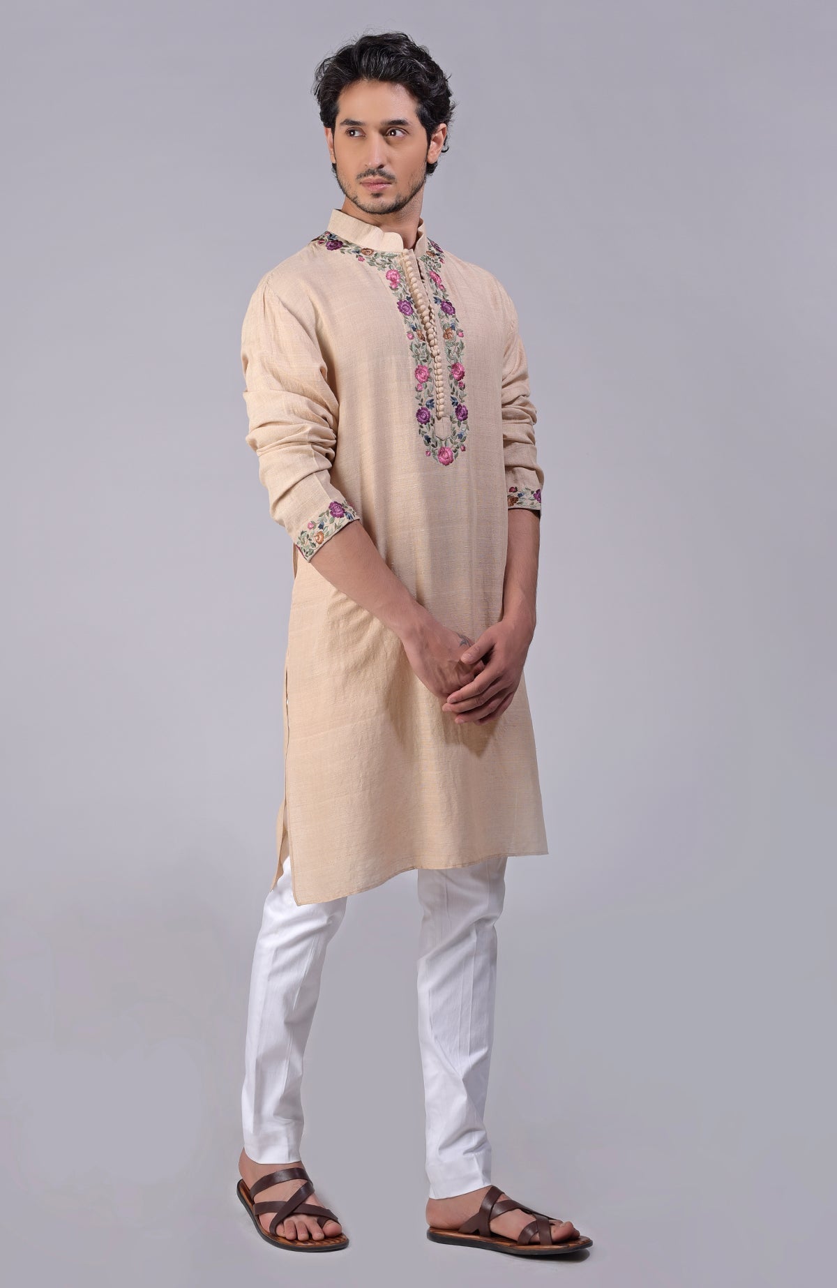 Beige kurta with multicolor Parsi Gara embroidery on placket, neckline, and sleeves.