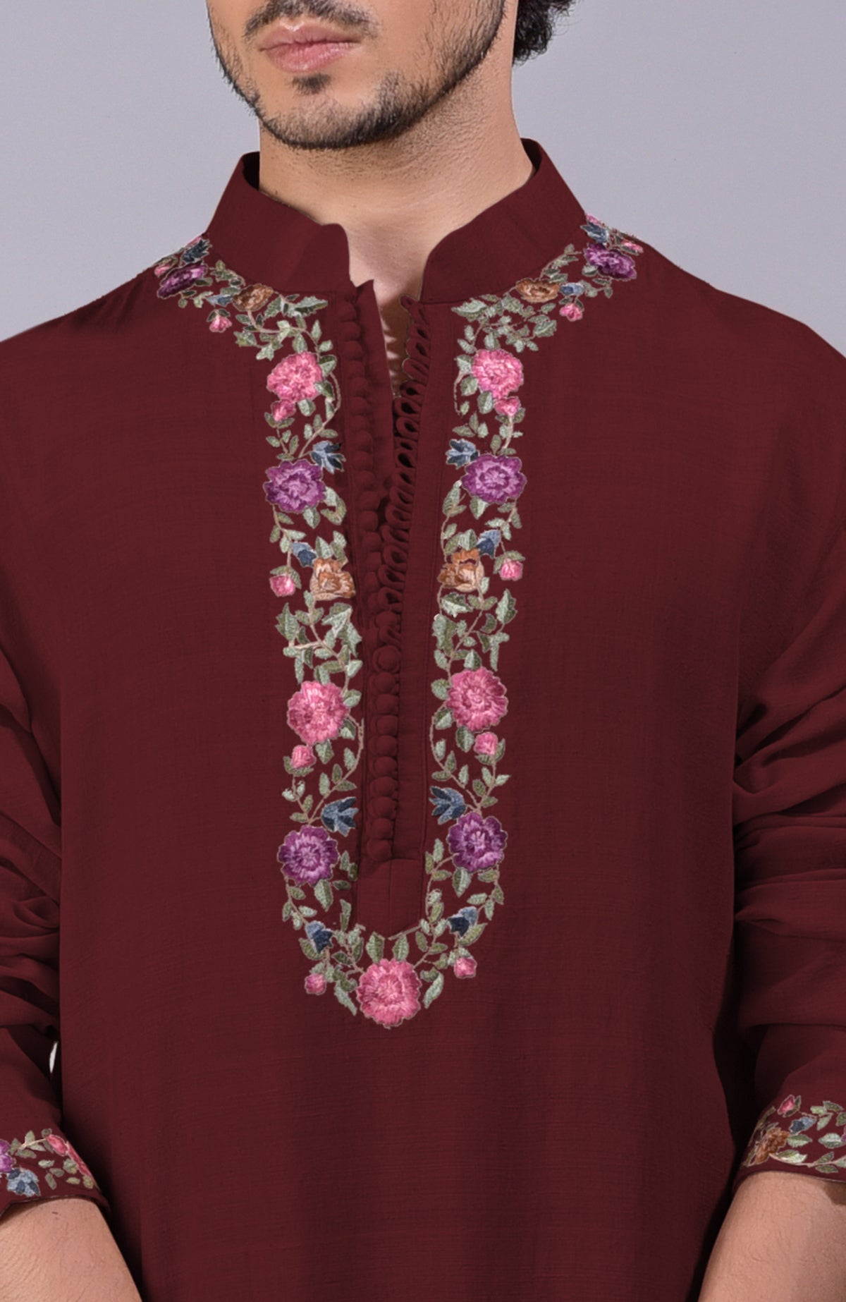 Maroon kurta with colorful Parsi Gara embroidery on placket, neckline, and sleeves.