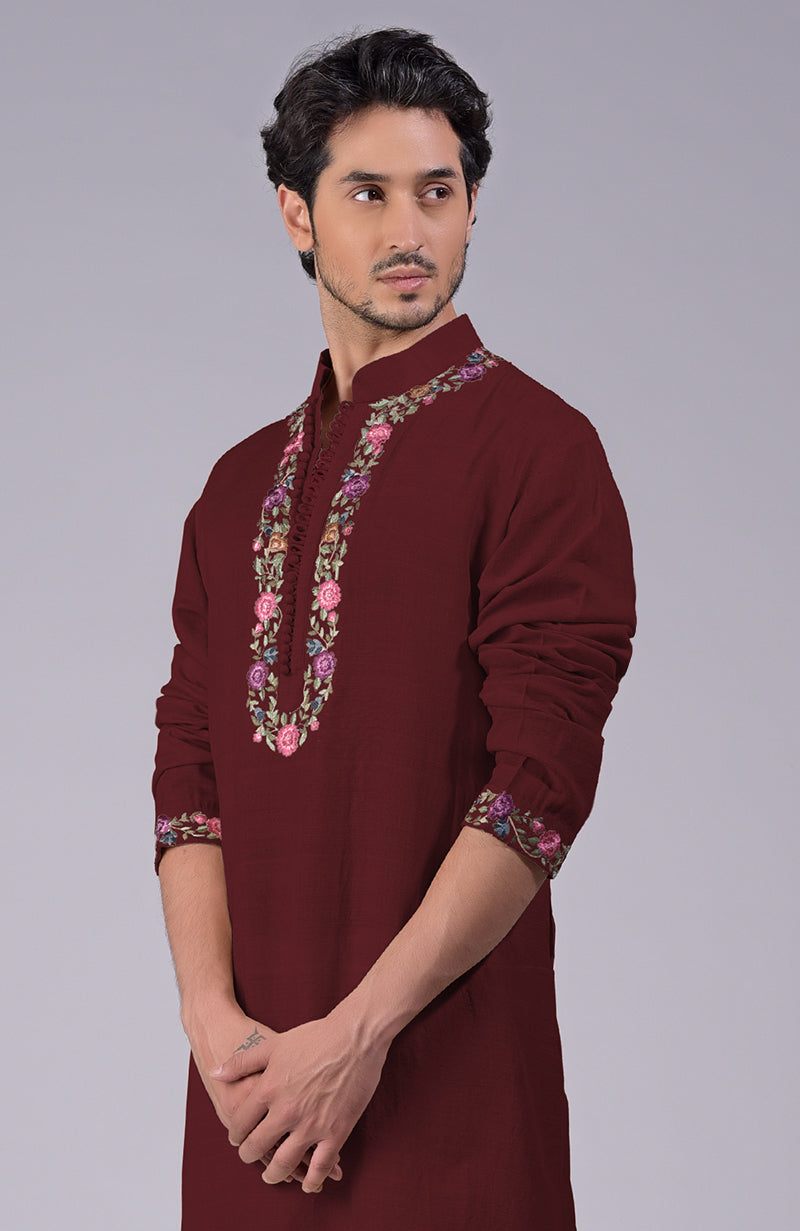 Maroon kurta with multicolor Parsi Gara embroidery on placket, neckline, and sleeves.