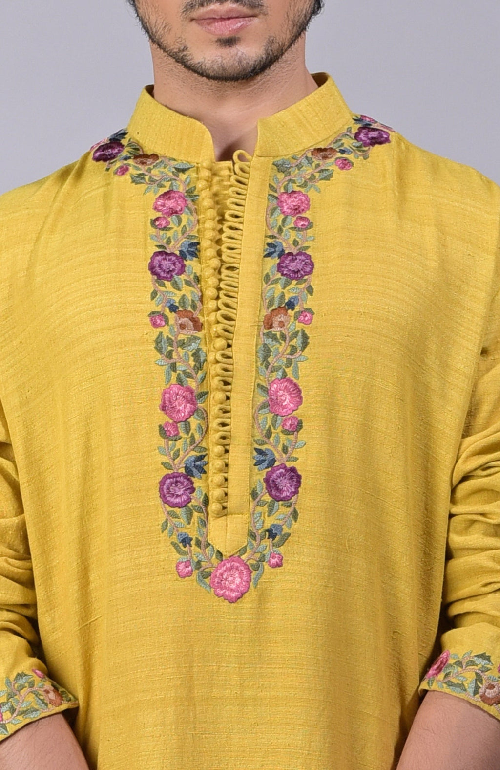 Misted marigold yellow kurta with Parsi Gara embroidery on placket, neckline, and sleeves.
