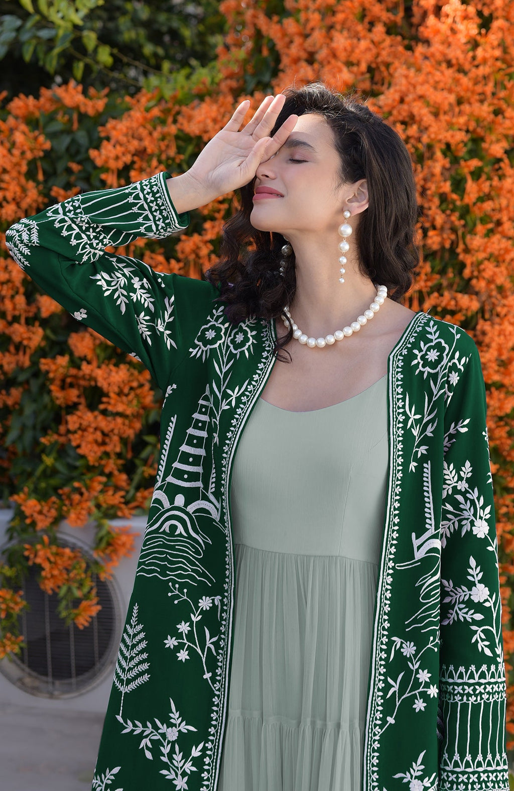 Emerald green Parsi Gara embroidered jacket with ivory motifs and sage green micropleated chiffon dress