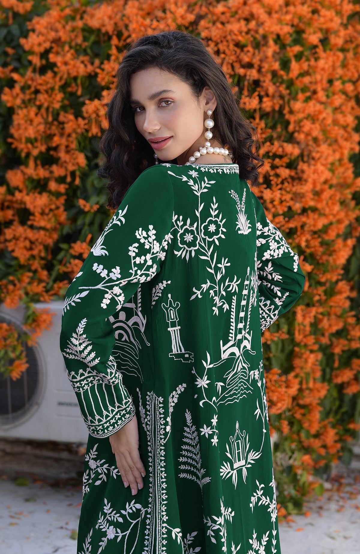 Emerald green Parsi Gara embroidered jacket with ivory motifs paired with sage green chiffon dress