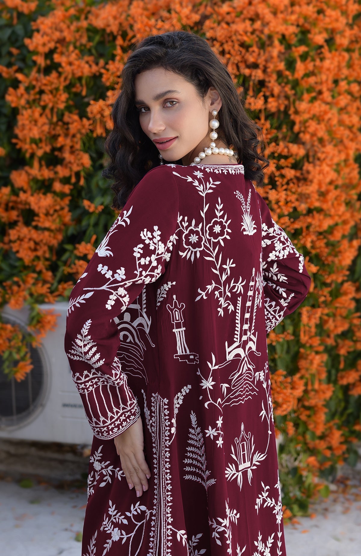 Maroon Parsi Gara embroidered jacket with ivory motifs paired with light pink micropleated chiffon dress