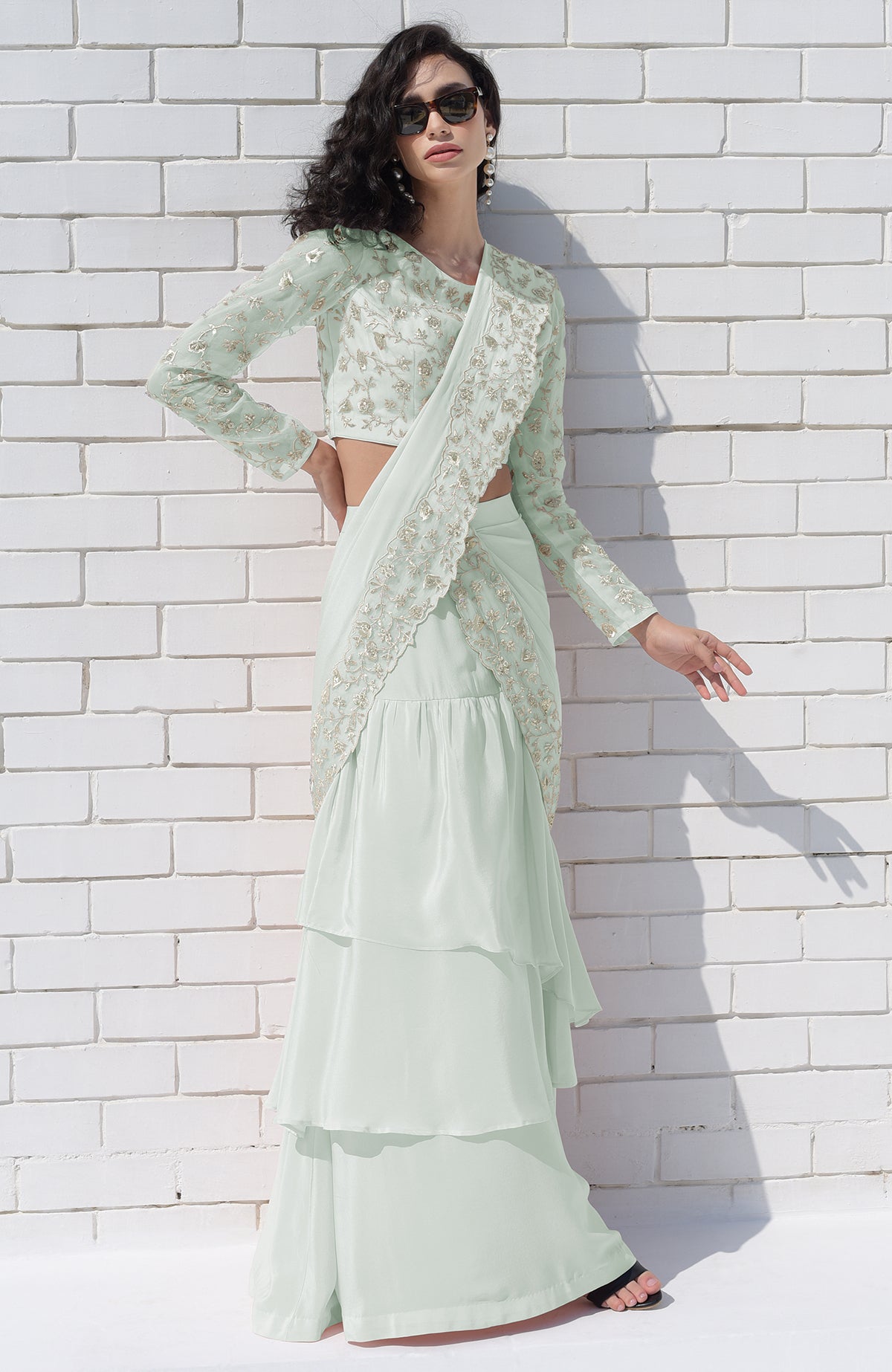 Sage green draped saree set with silver floral embroidery.