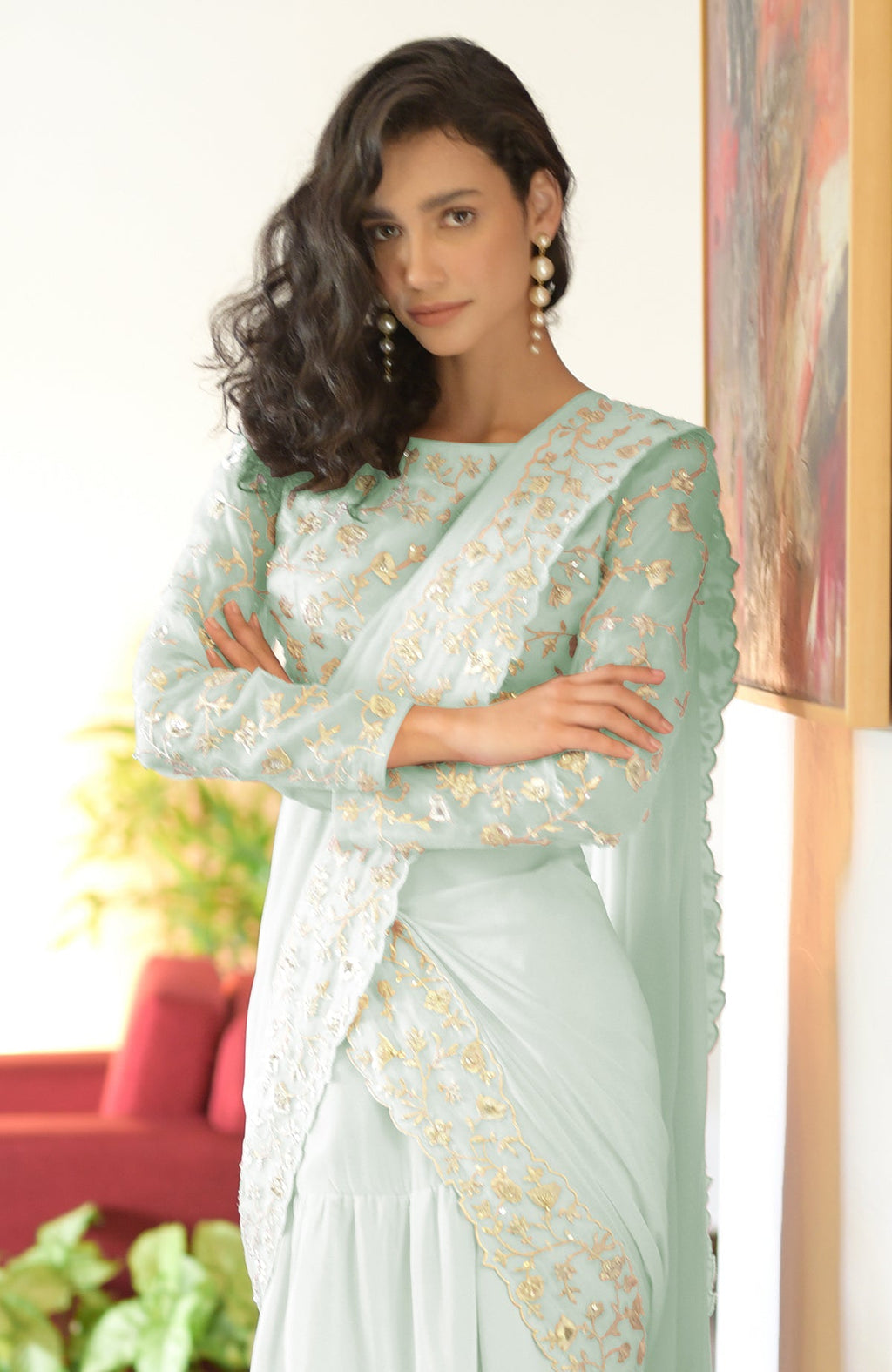 Sage green draped saree set with silver floral embroidery.