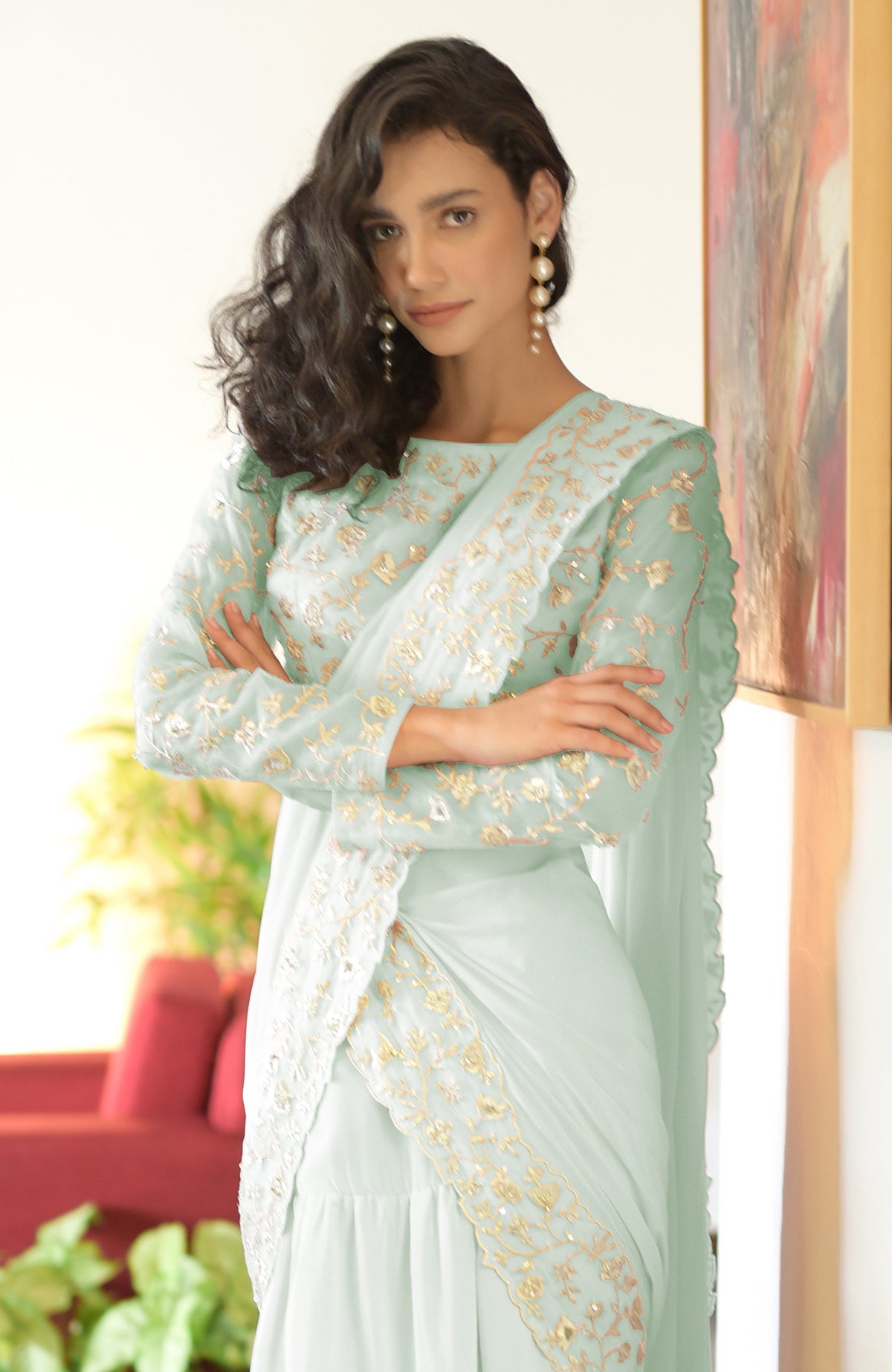 Sage green draped saree set with silver floral embroidery.