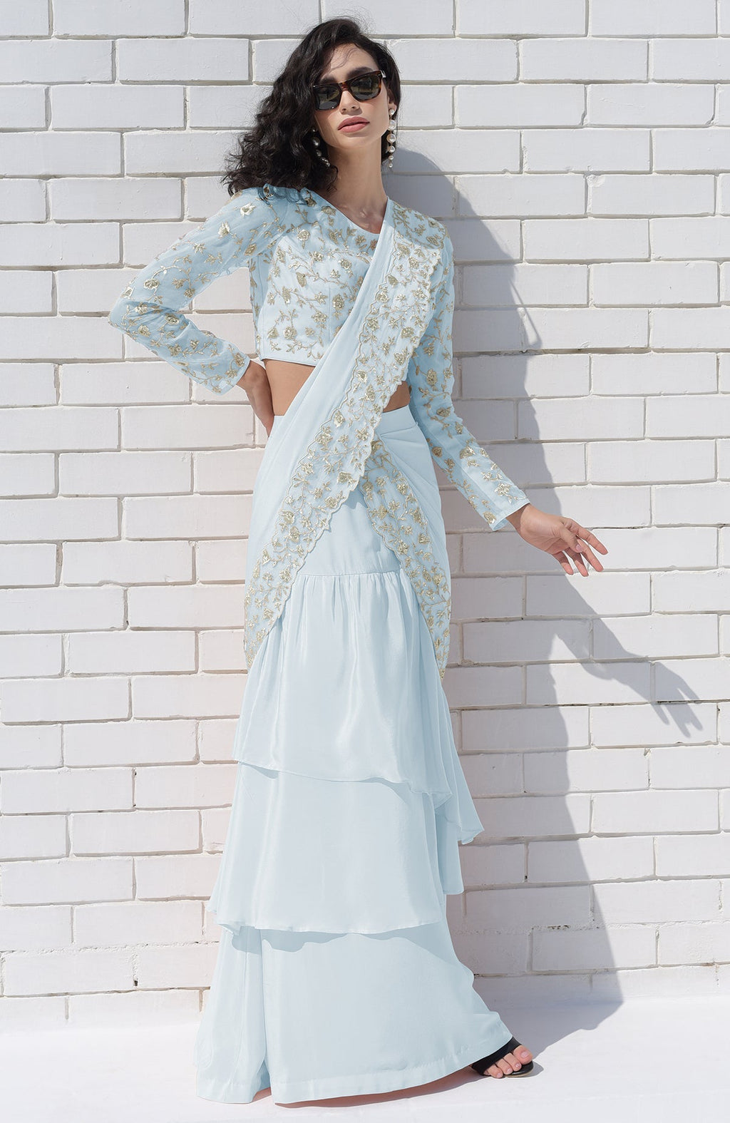 Aqua blue draped saree set with silver floral embroidery and tiered skirt.