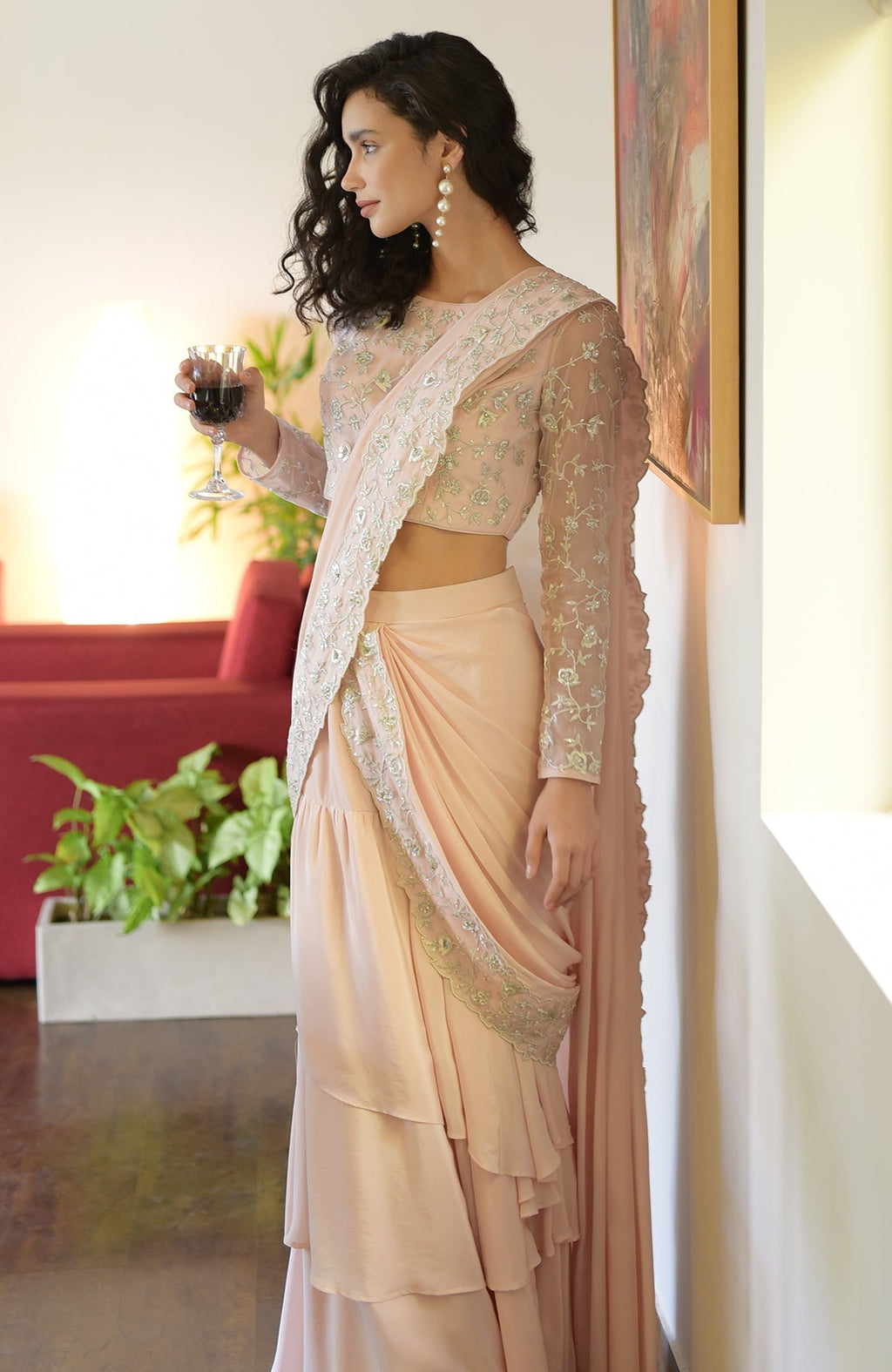 Nude pink saree with silver floral embroidery, scalloped borders, and a boat neck blouse with long sleeves