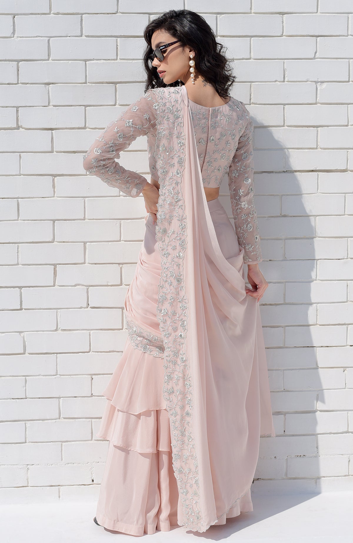 Nude pink saree with silver floral embroidery, scalloped borders, and a long-sleeve blouse