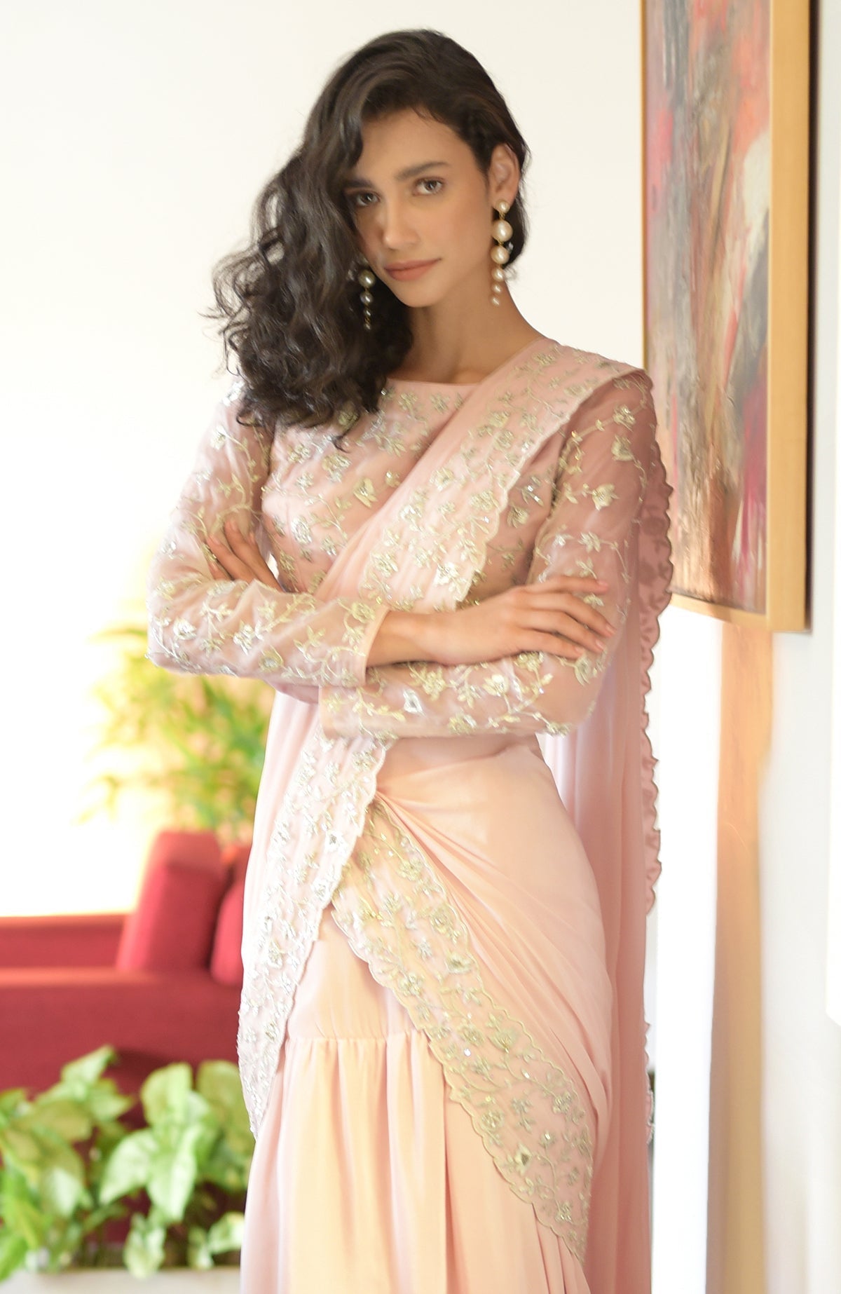 Nude pink saree with silver floral embroidery, scalloped borders, and a long-sleeve blouse