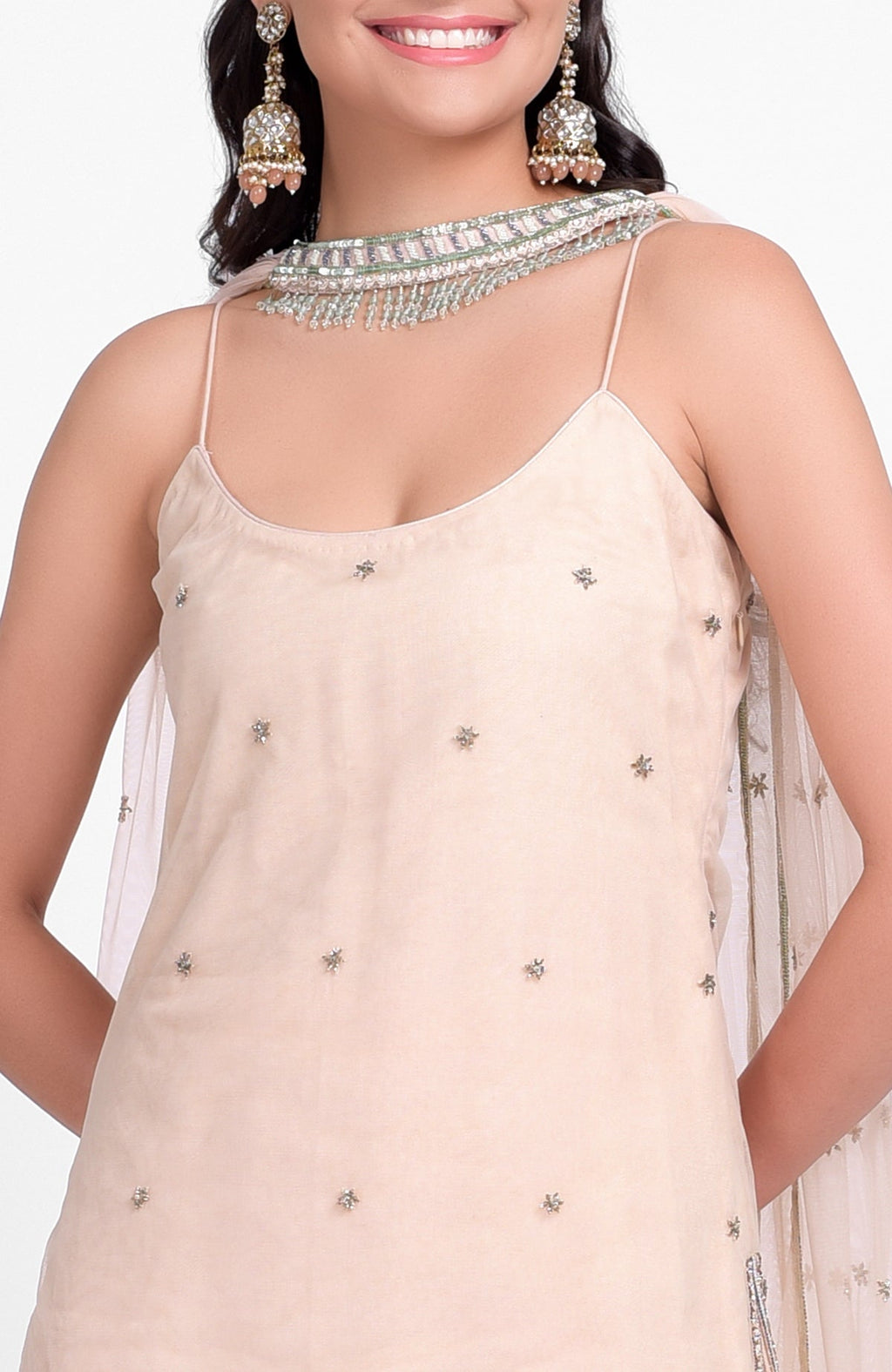 Champagne pink sharara set with bead sequins, hand embroidery, and tulle dupatta with jeweled choker.