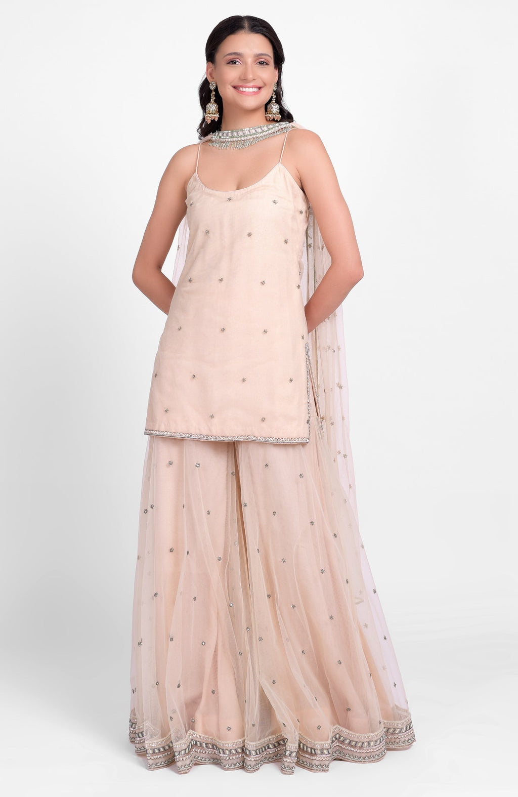 Champagne pink sharara set with bead sequins, hand embroidery, and tulle dupatta with jeweled choker.