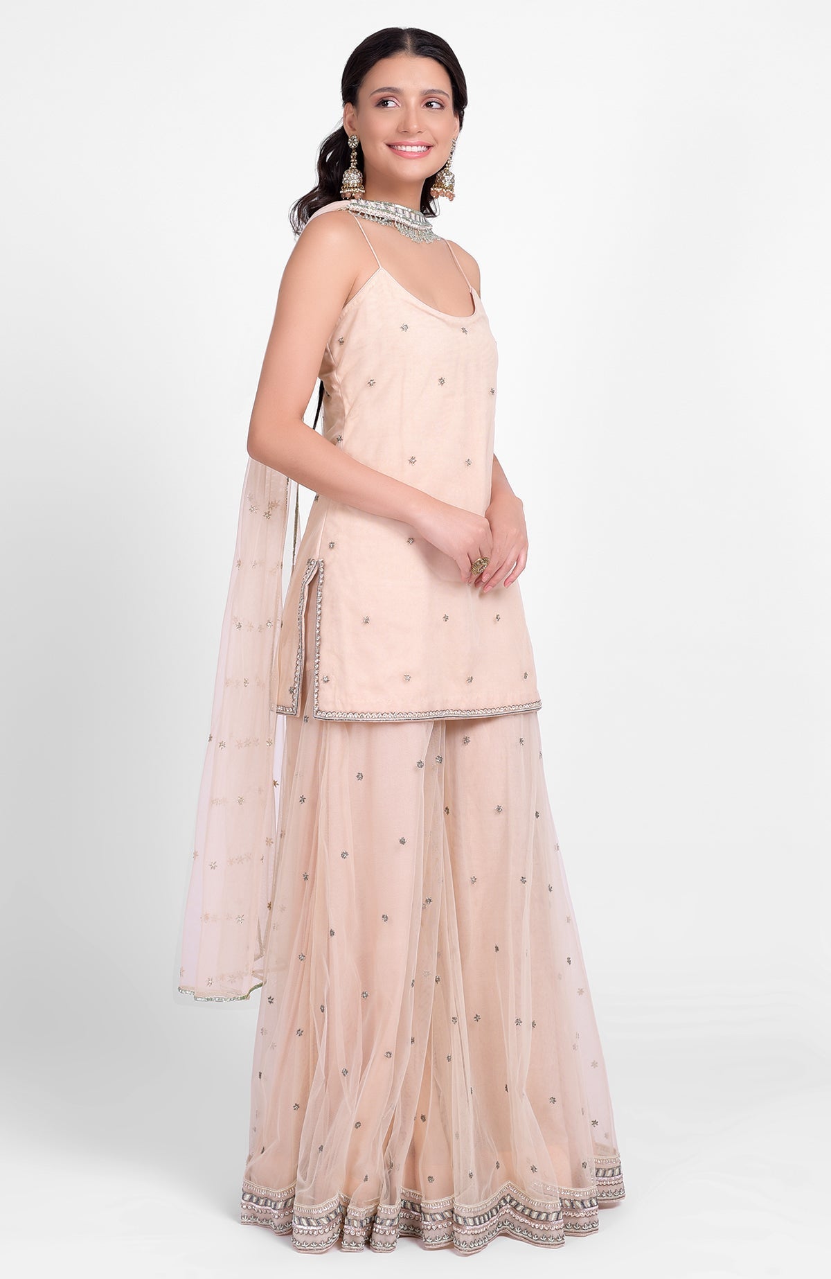 Champagne pink sharara set with bead sequin embroidery and delicate tulle dupatta with jeweled choker.