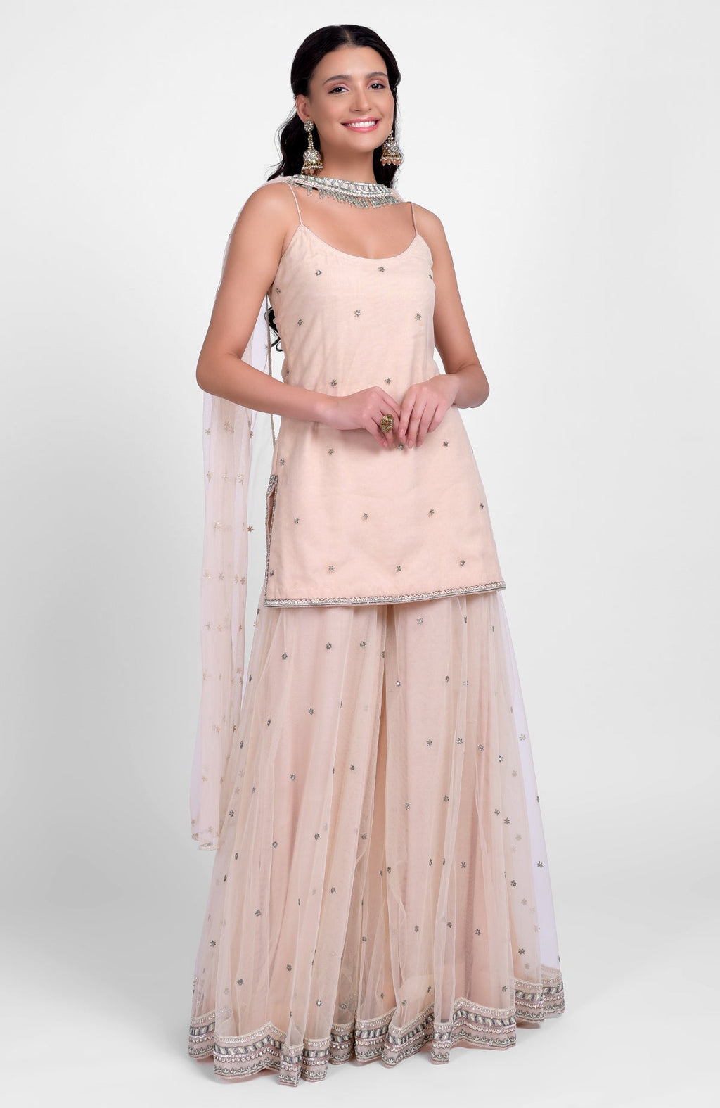 Champagne pink sharara set with bead sequins, hand embroidery, and tulle dupatta with jeweled choker.