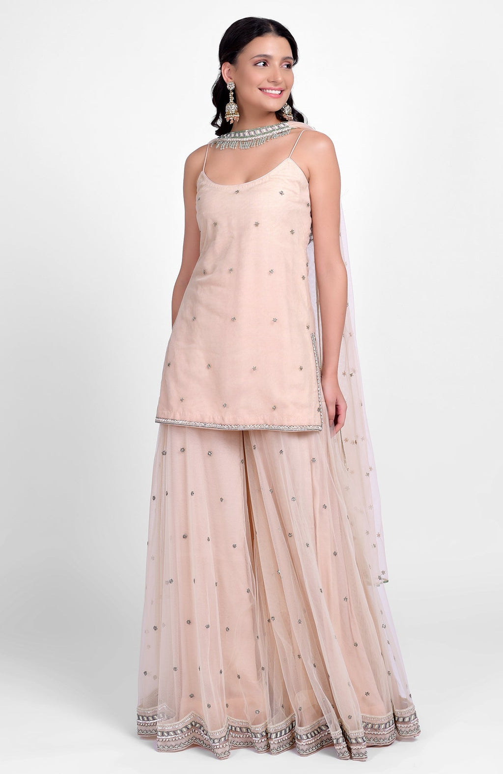 Champagne pink sharara set with bead sequins, hand embroidery, and tulle dupatta with jeweled choker.