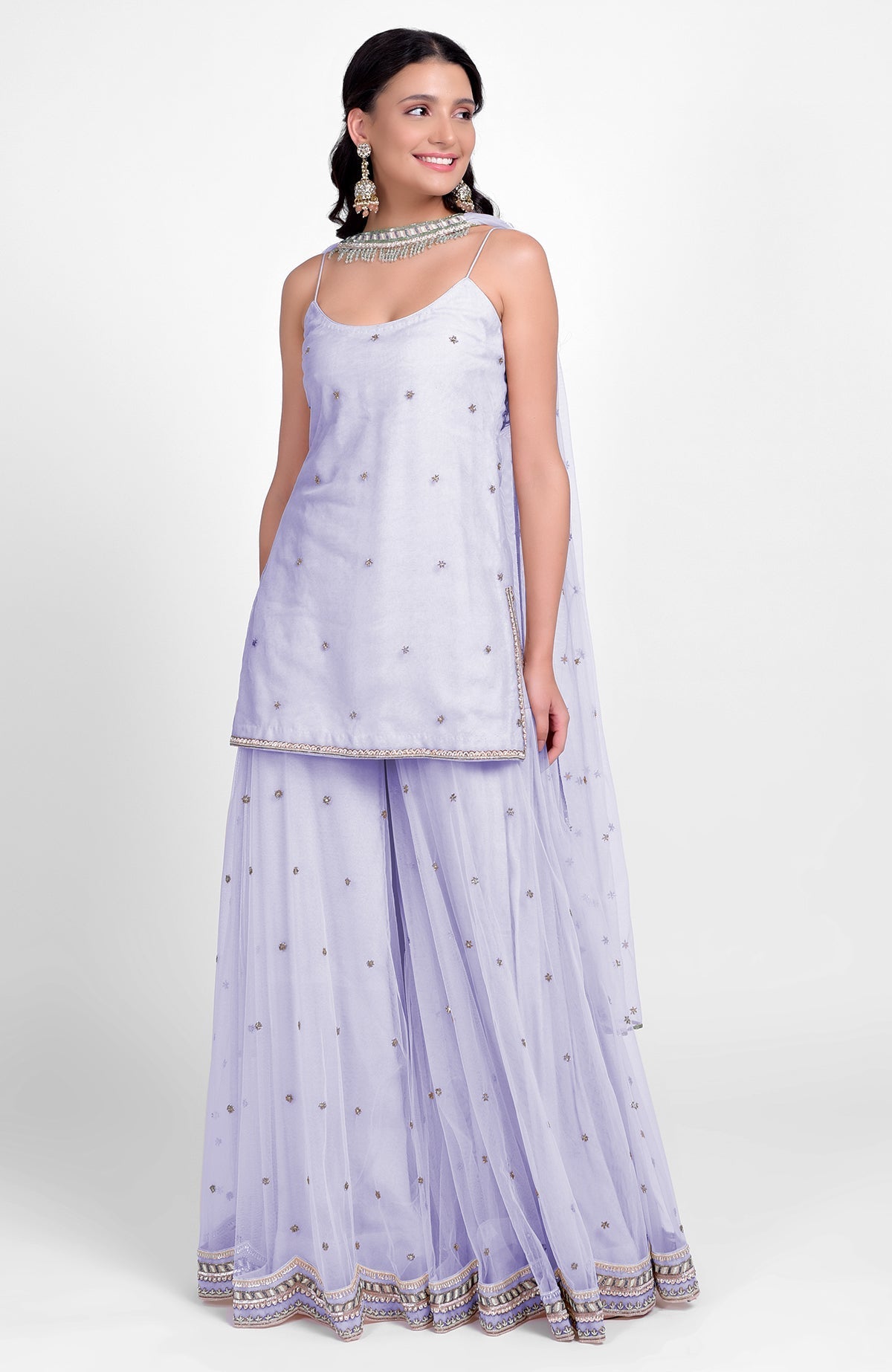 Champagne pink sharara set with bead sequins, hand embroidery, and tulle dupatta with jeweled choker.