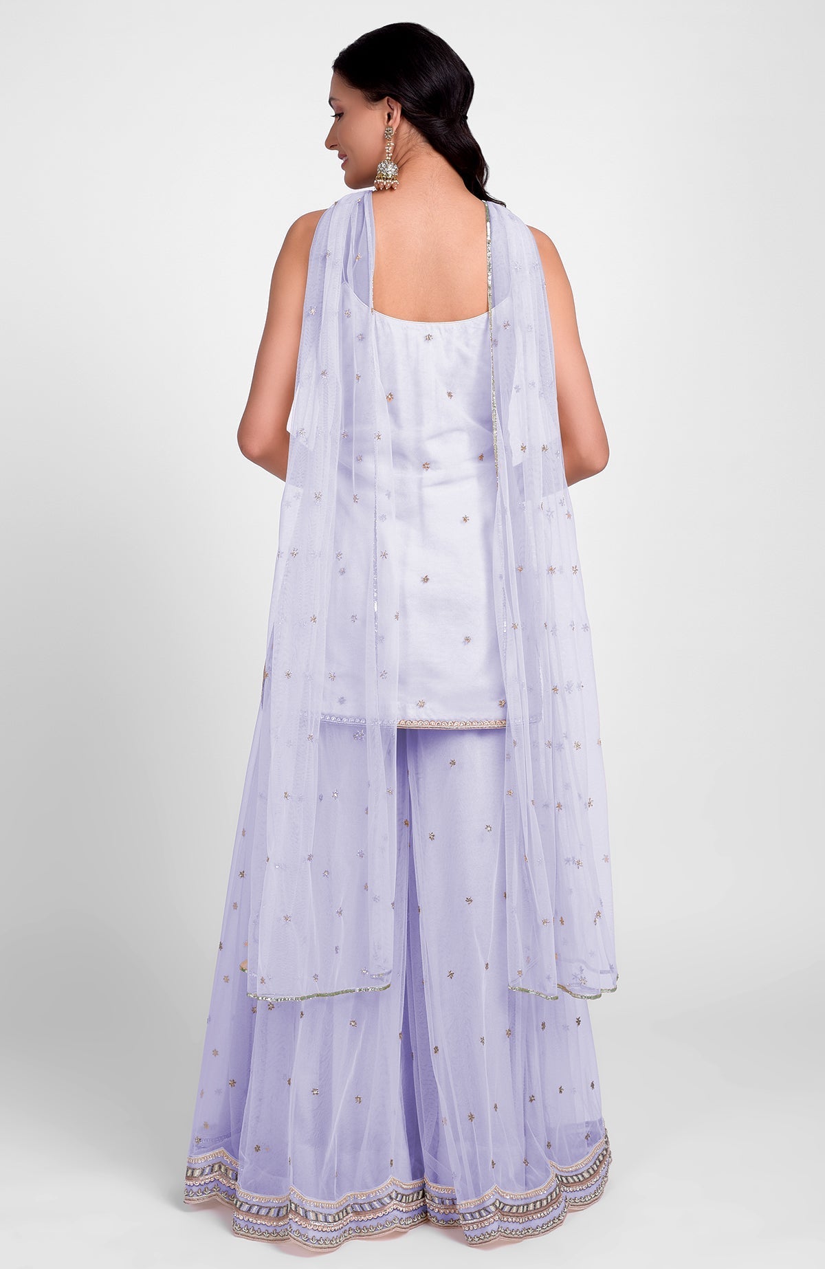 Lilac sharara set with bead sequins, hand embroidery, flared kurta, and jeweled tulle dupatta.