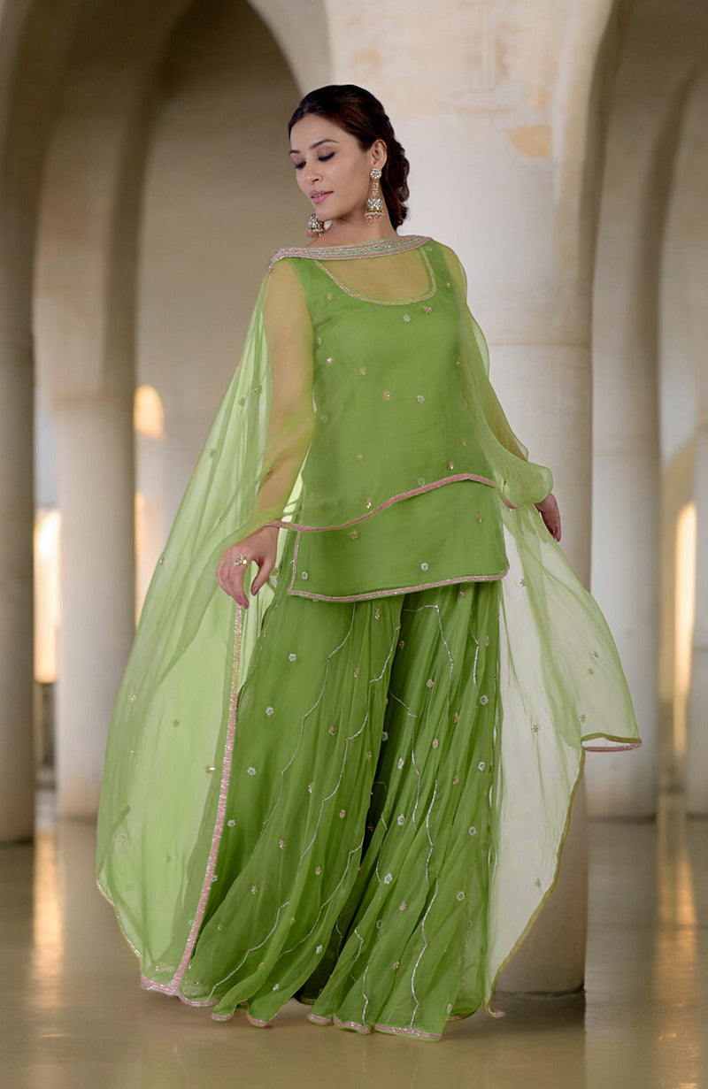 Lime green hand-embroidered sharara cape set with a scoop neck kurta and circular cut sharara.