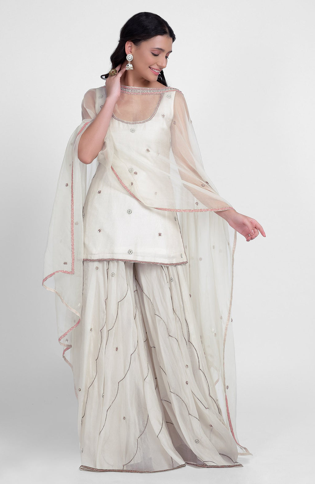 Off-white silk organza sharara set with hand embroidery, scoop neck kurta, and cape dupatta