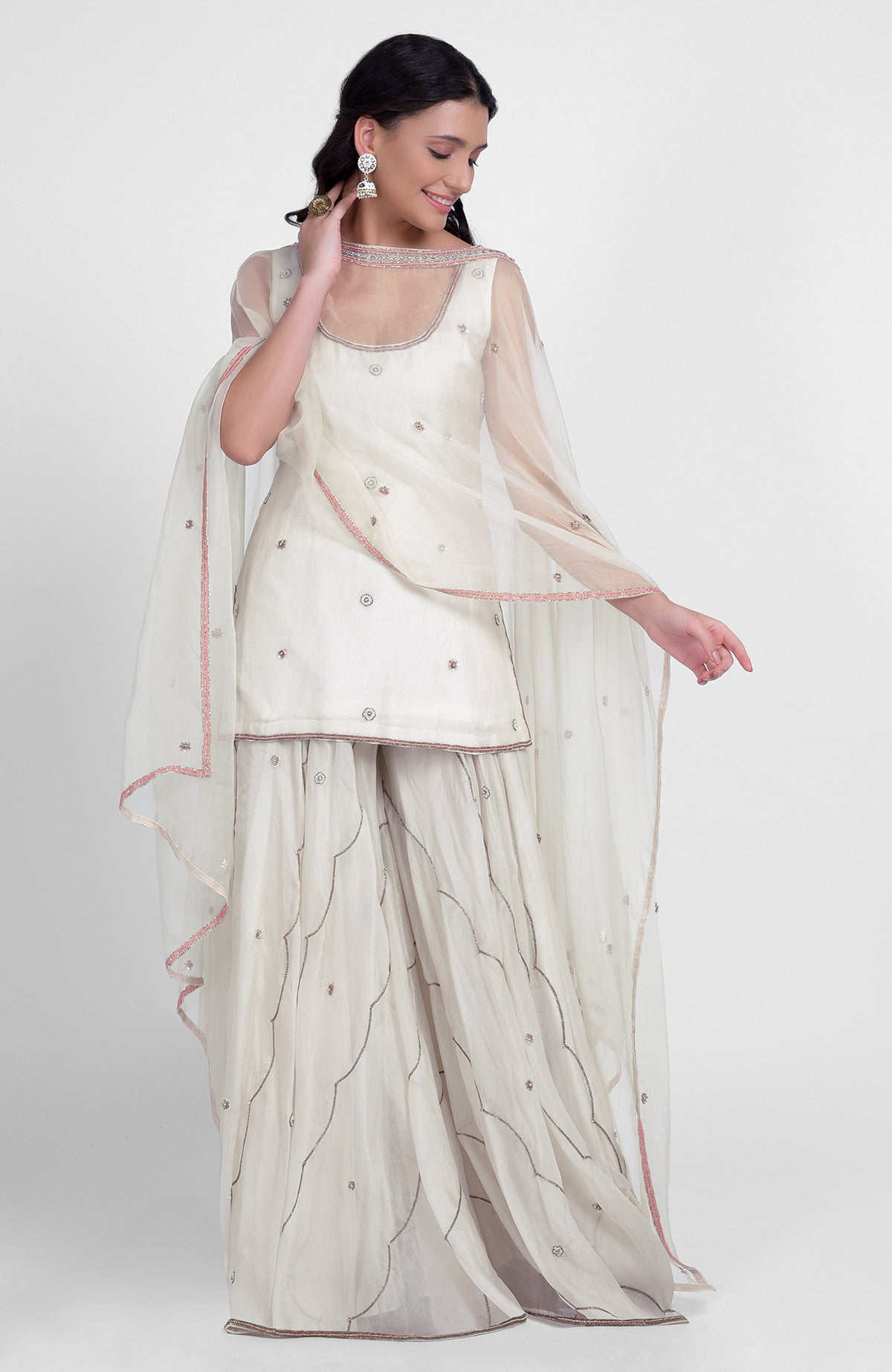 Off-white silk organza sharara set with hand embroidery, scoop neck kurta, and cape dupatta