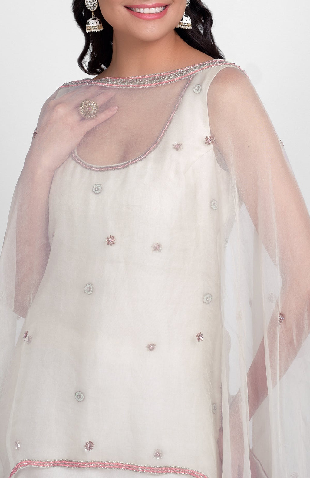 Off-white silk organza sharara set with pastel hand embroidery and a cape dupatta