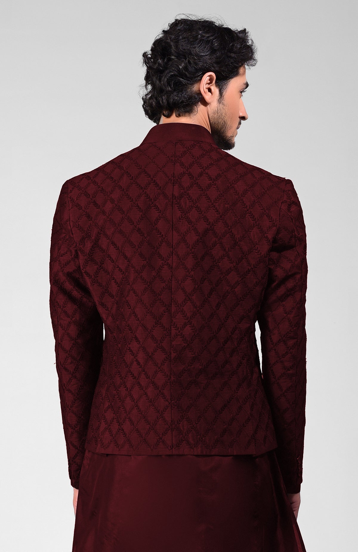 Maroon raw silk bandhgala jacket with geometric floral embroidery all over.