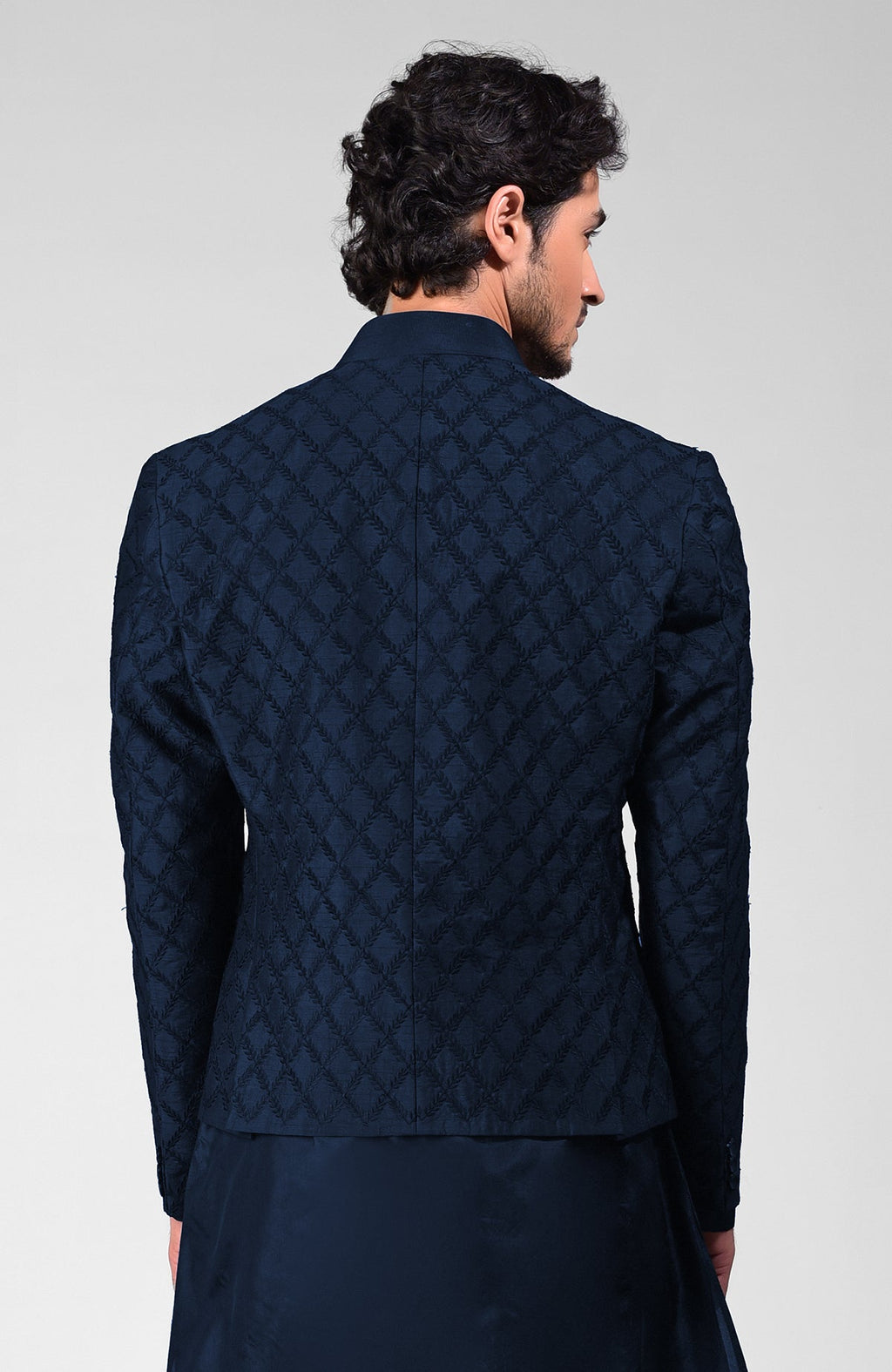 Navy blue raw silk bandhgala jacket with geometric floral embroidery all over.