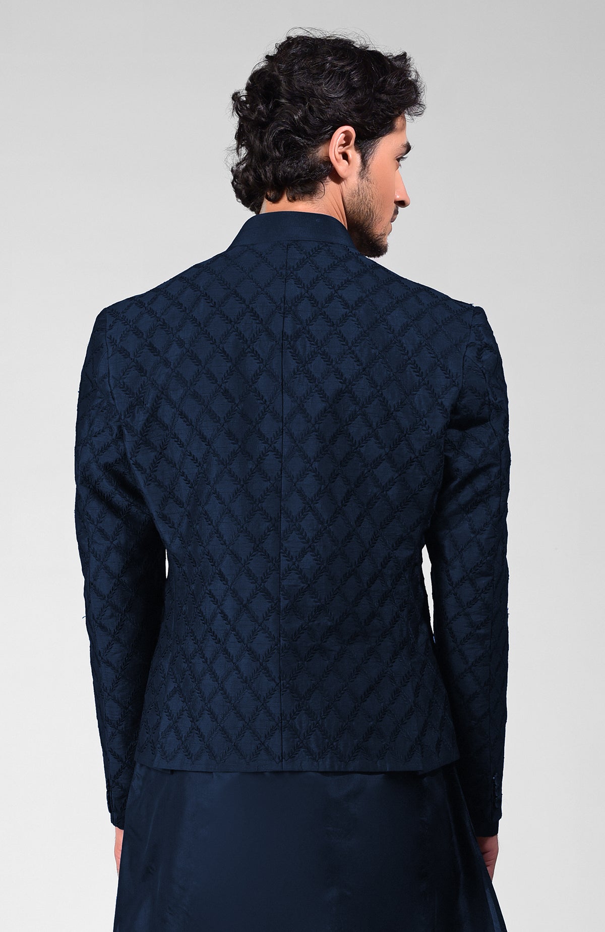 Navy blue raw silk bandhgala jacket with geometric floral embroidery all over.