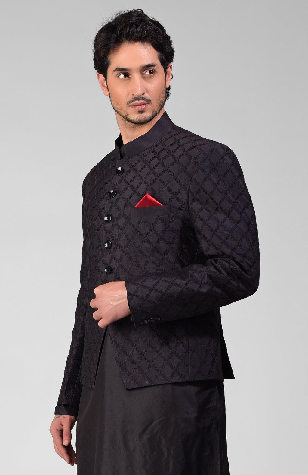 Black Chikankari embroidered Bandhgala jacket set with a red pocket square.