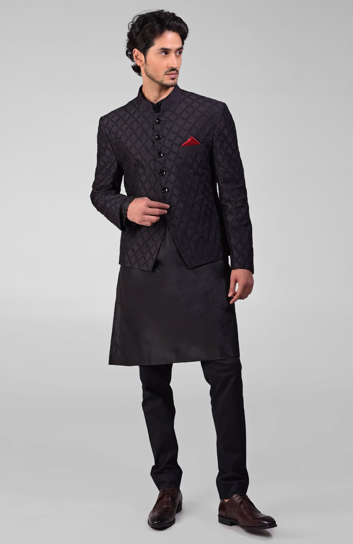 Black silk Bandhgala jacket with intricate chikankari floral embroidery in a three-piece set.
