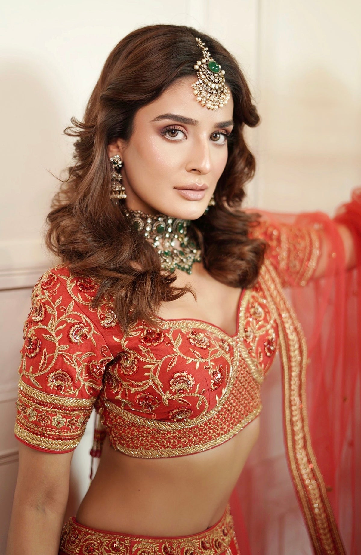 Scarlet red lehenga set with gold kasab and zardozi embroidery and matching tulle dupatta.