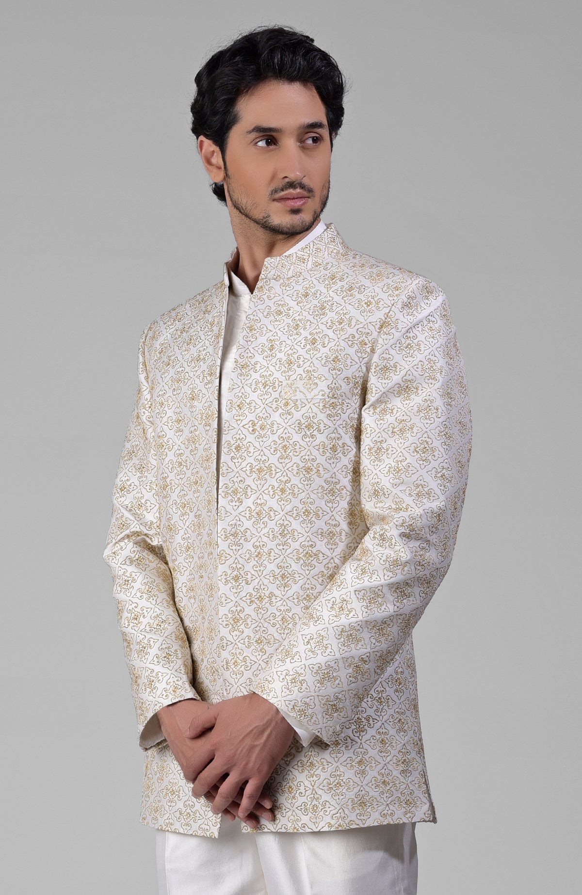 Ivory gold embroidered silk jacket set with open jacket, short kurta, and slim pants.