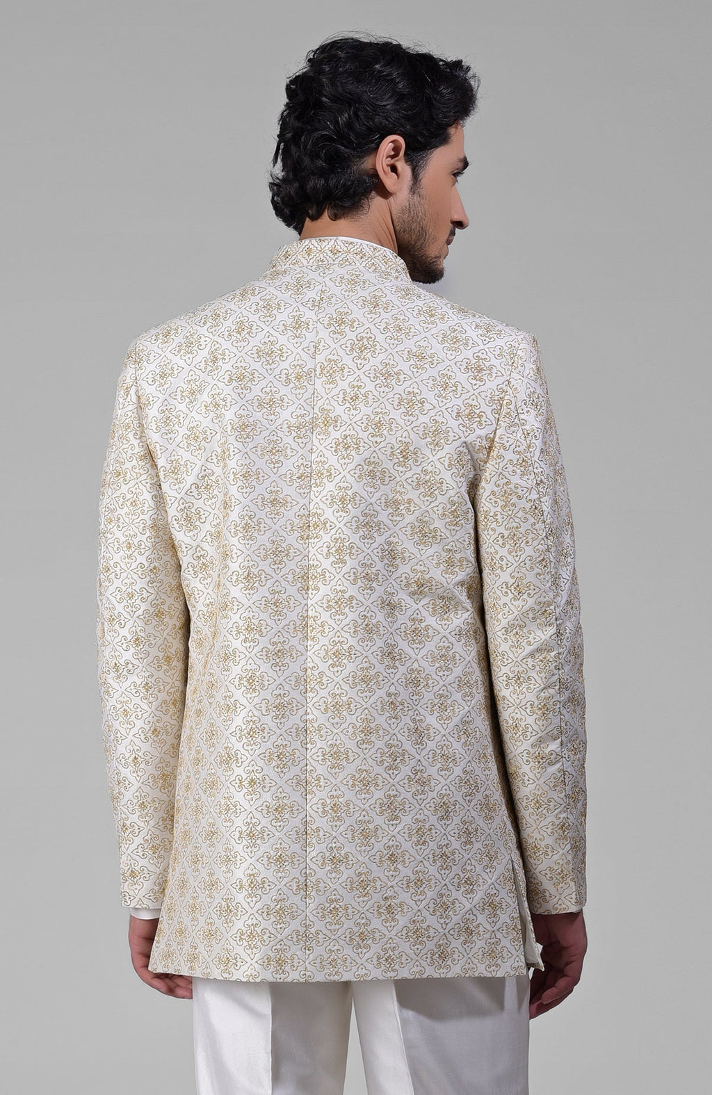 Ivory silk jacket set with gold embroidery, open jacket, short kurta, and slim pants.