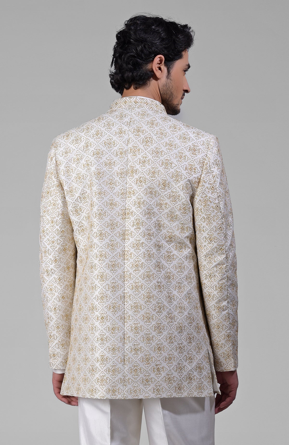 Ivory silk jacket set with gold embroidery, open jacket, short kurta, and slim pants.