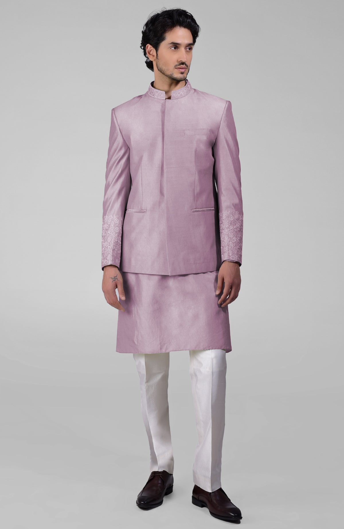 Sage green three-piece silk set with embroidered bandhgala jacket, kurta, and pants.
