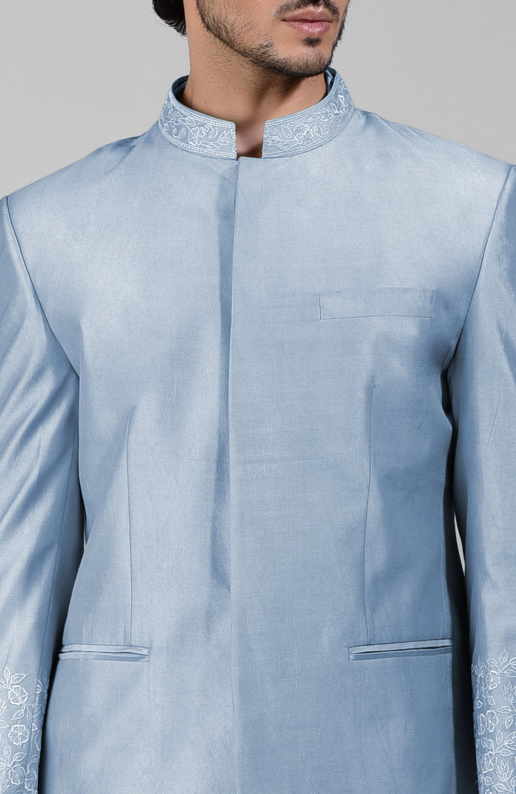 Dusty blue silk bandhgala jacket with thread embroidery, kurta, and pants set.