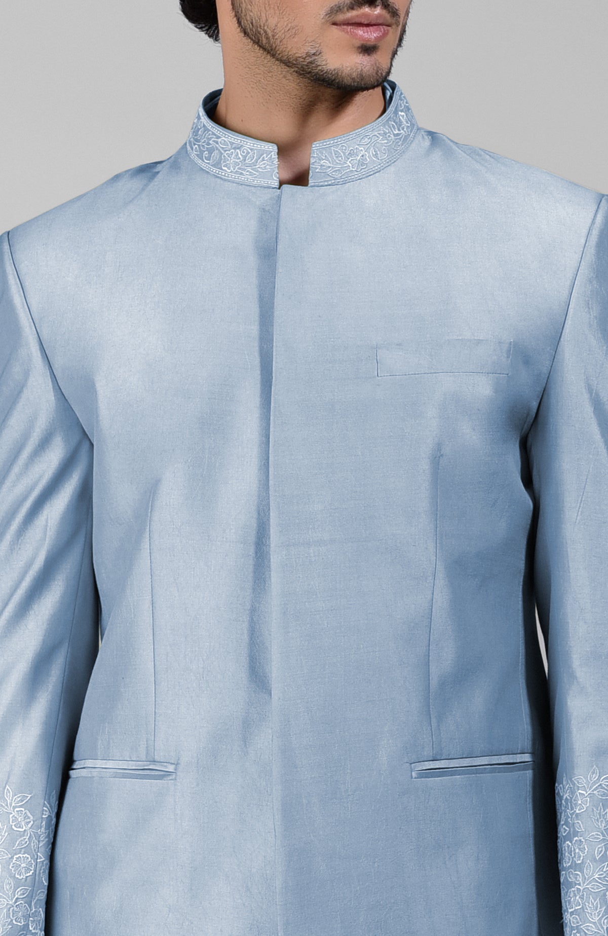 Dusty blue silk bandhgala jacket with thread embroidery, kurta, and pants set.