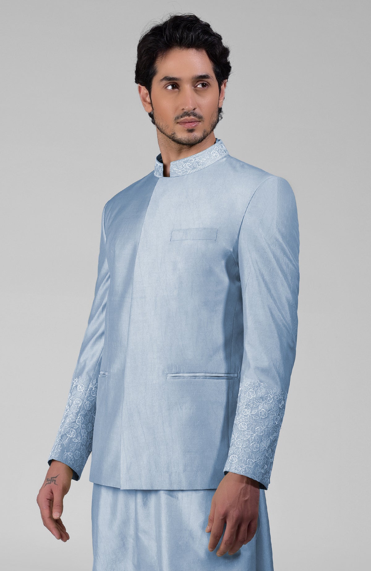 Dusty blue silk three-piece set with embroidered bandhgala jacket, kurta, and pants.