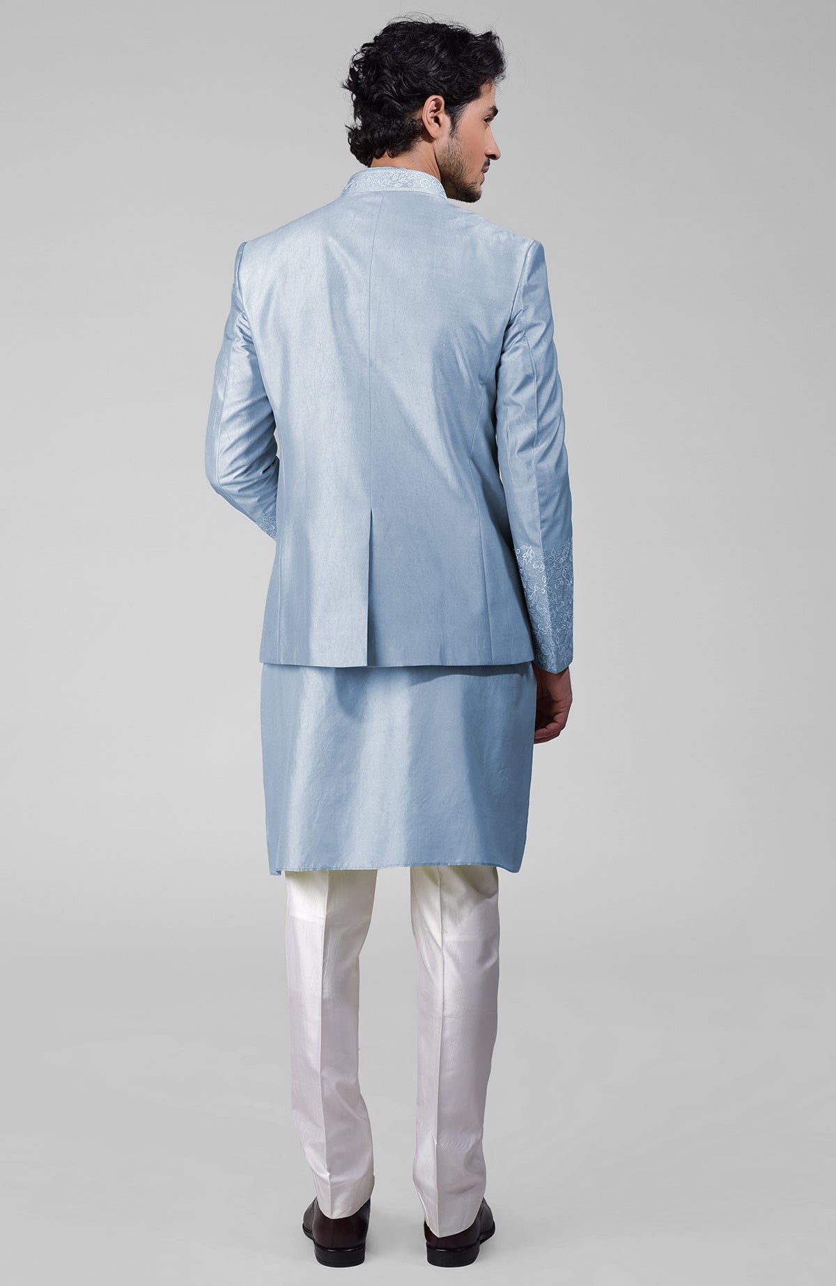 Dusty blue silk bandhgala jacket with thread embroidery, kurta, and pants set.