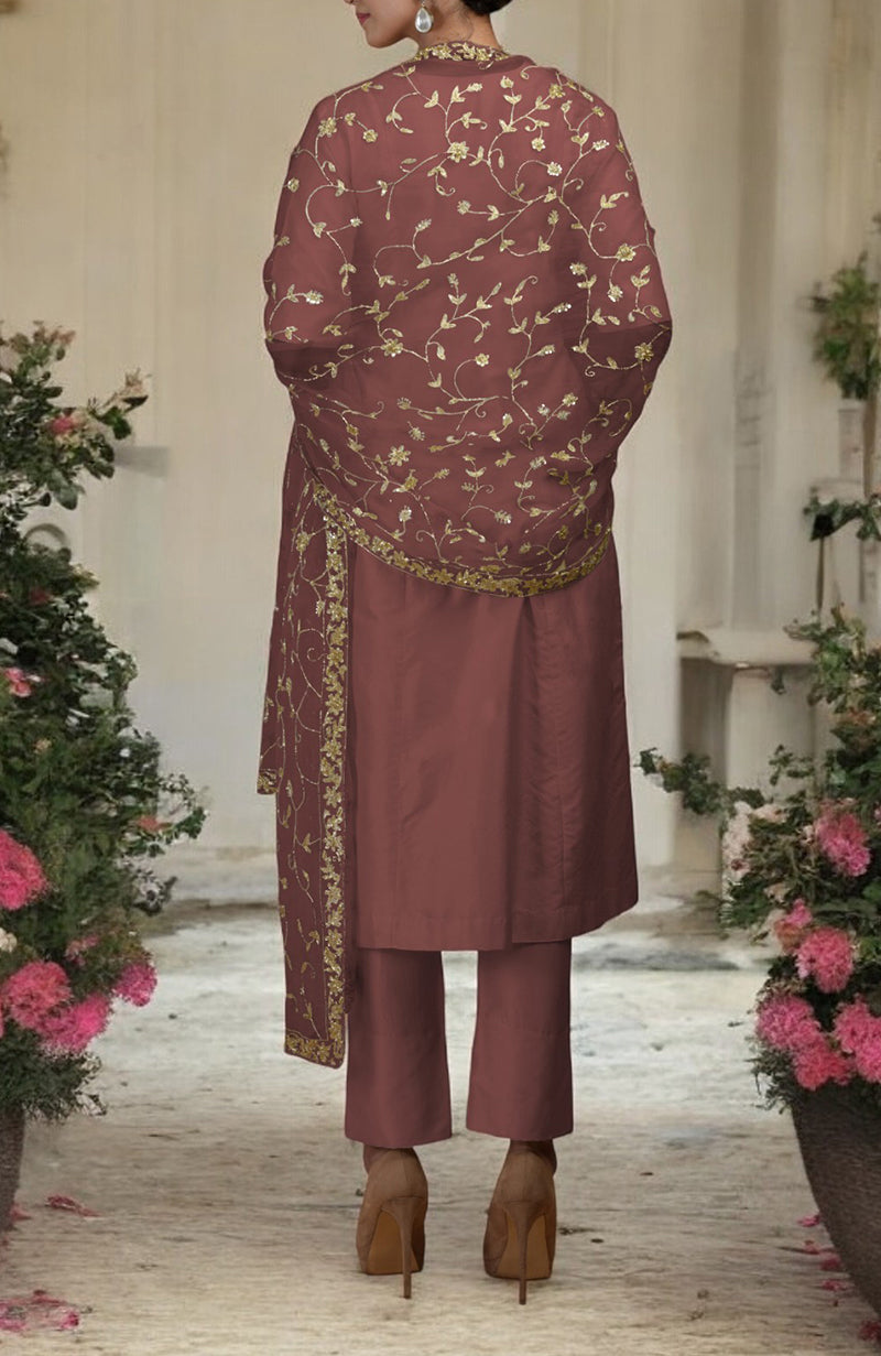 A woman from behind wears a chutney-gold zardozi hand-embroidered dupatta with a matching suit.