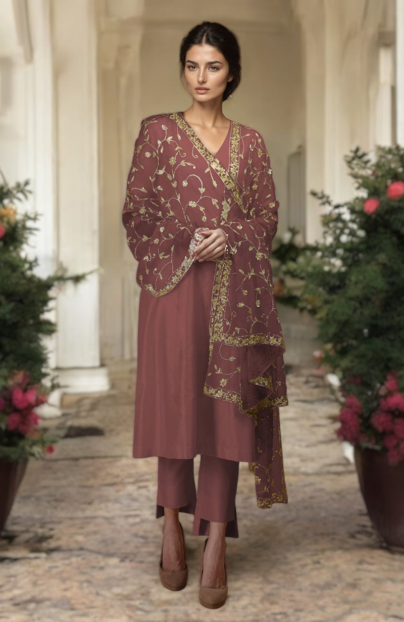 A woman models a chutney-gold zardozi hand-embroidered dupatta with a matching suit.